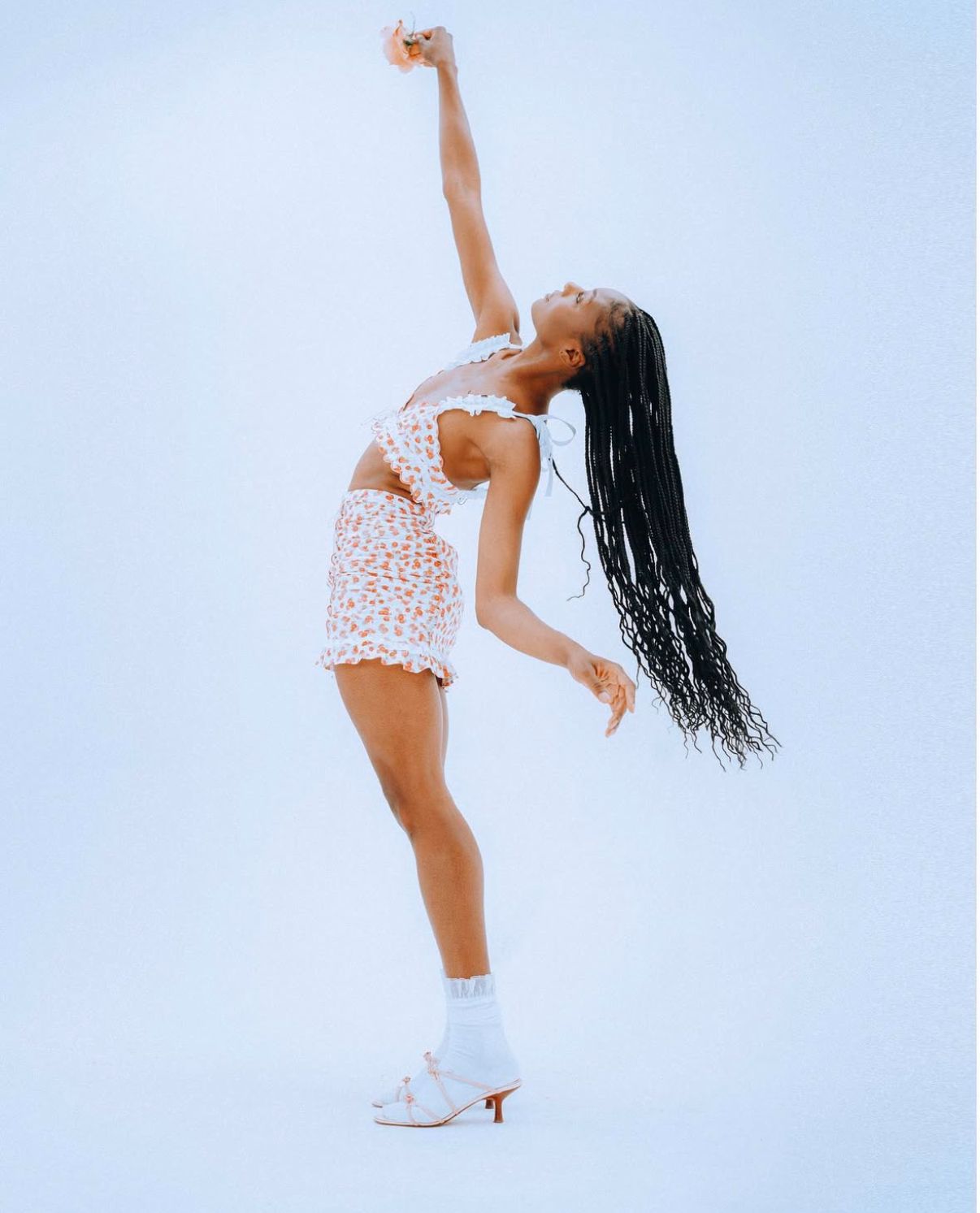 Flowing hair movement captured in elegant dance pose with white lace details.