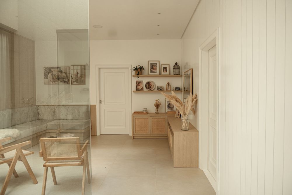 Clean minimalist room with wooden furniture and decorative wall shelves.