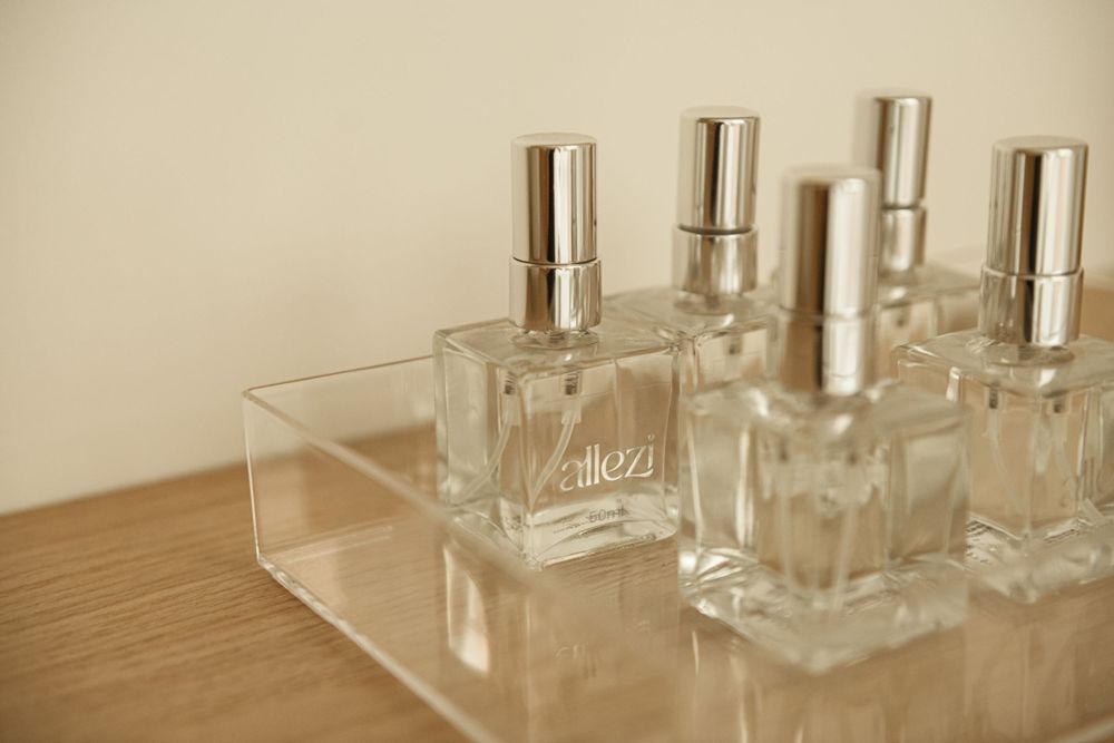 Clear glass perfume bottles arranged neatly on a wooden surface.