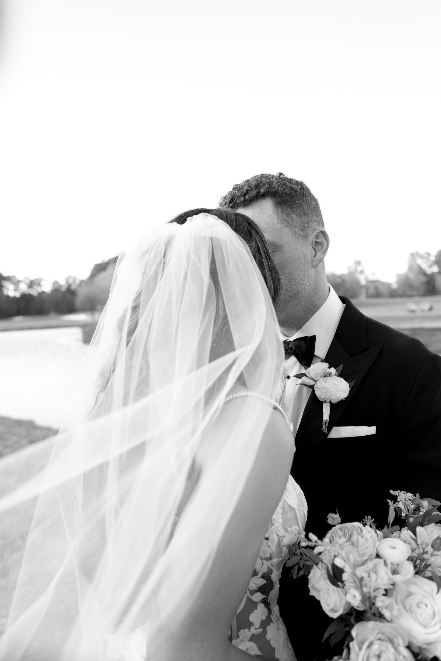 Artistic black and white wedding portraits showing veil and formal attire details.