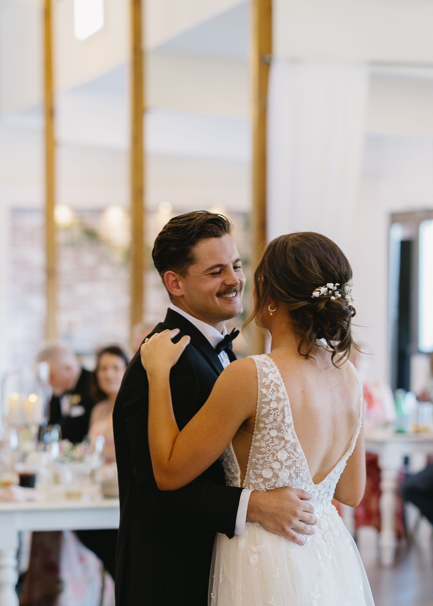 A couple shares their first dance in an elegant reception hall.