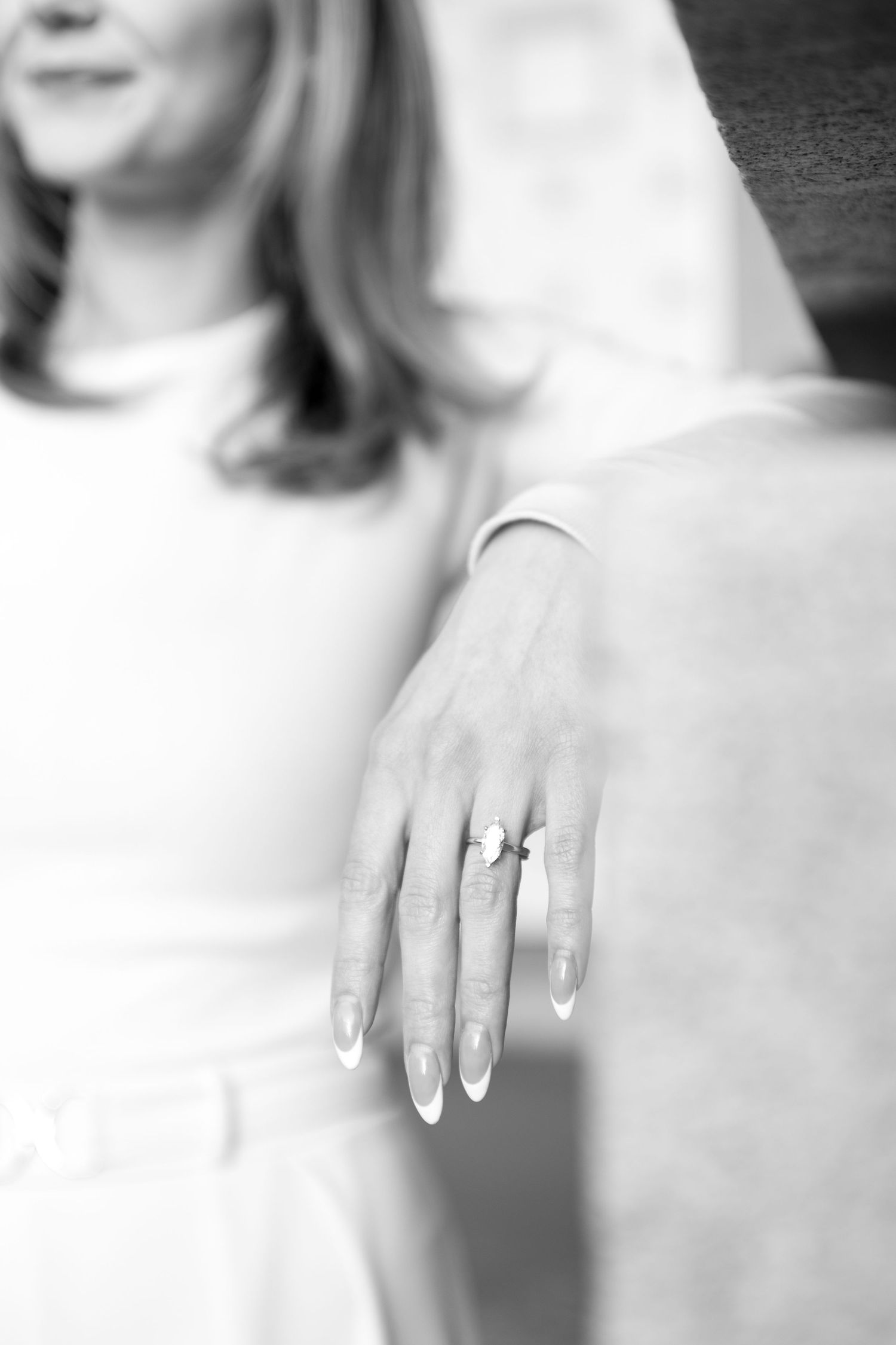 Close-up sequence showing an engagement ring on a manicured hand.