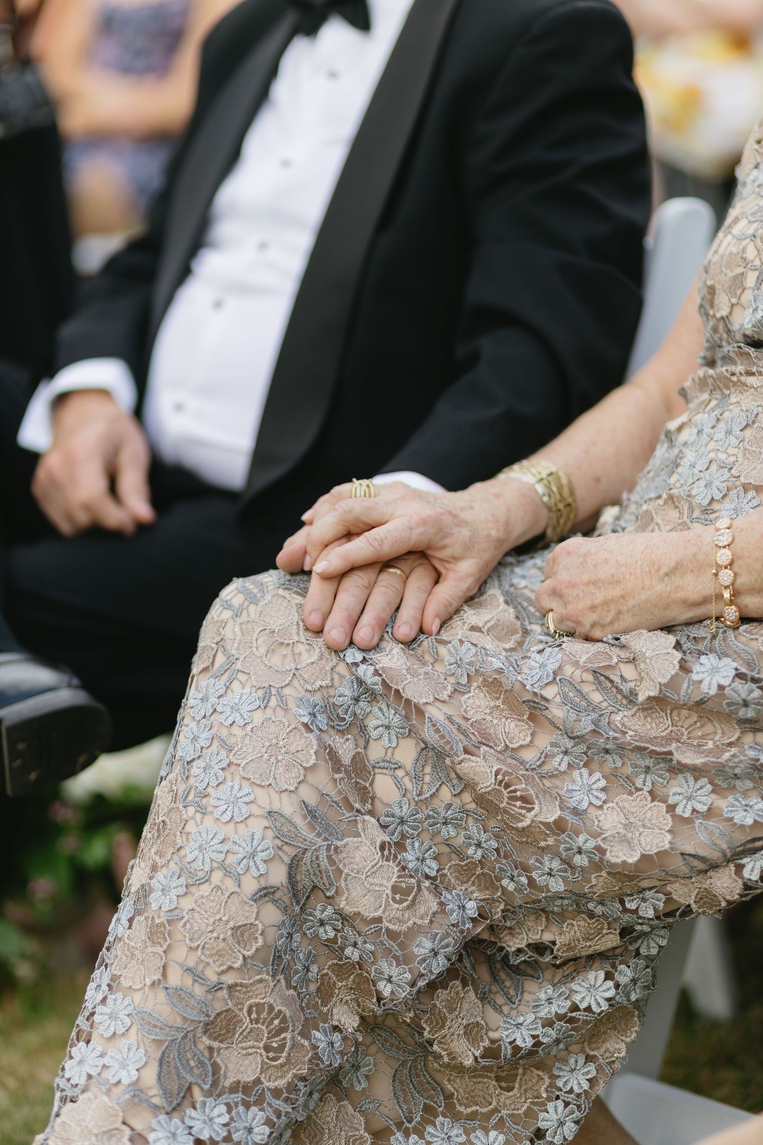 Close-up details of intricate lace and beading on a wedding dress.