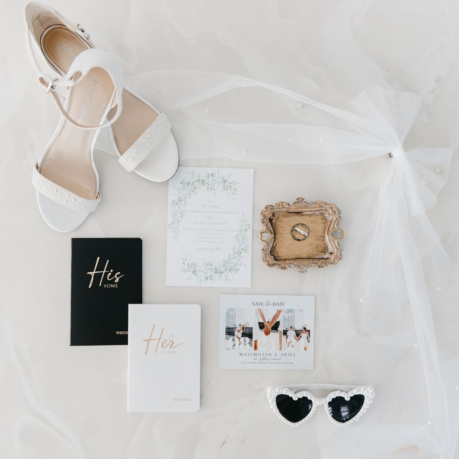 Wedding flat lay with white shoes, vows books, and decorative details.