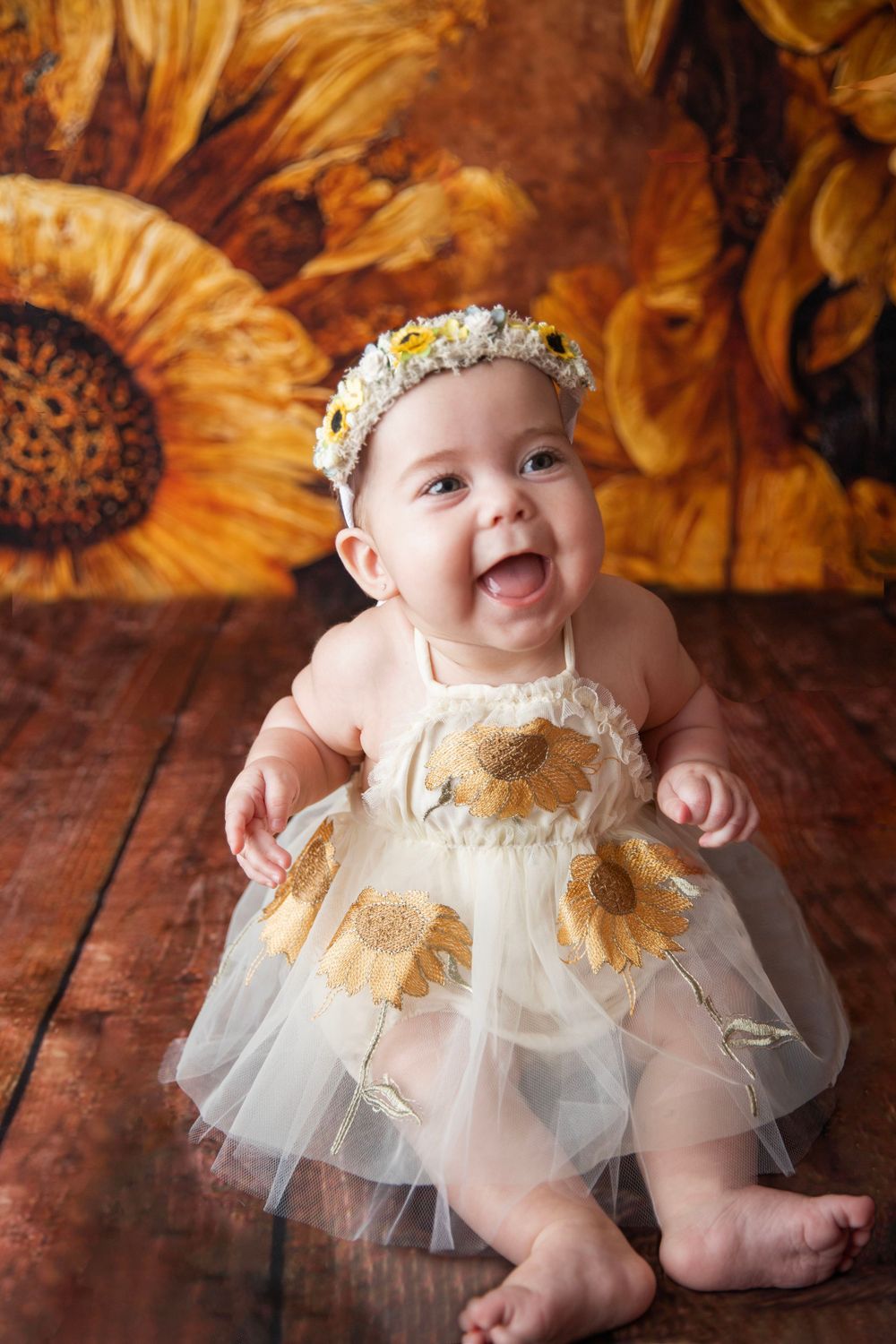 Baby girl in sunflower outfit during milestone photography session in Central Florida.