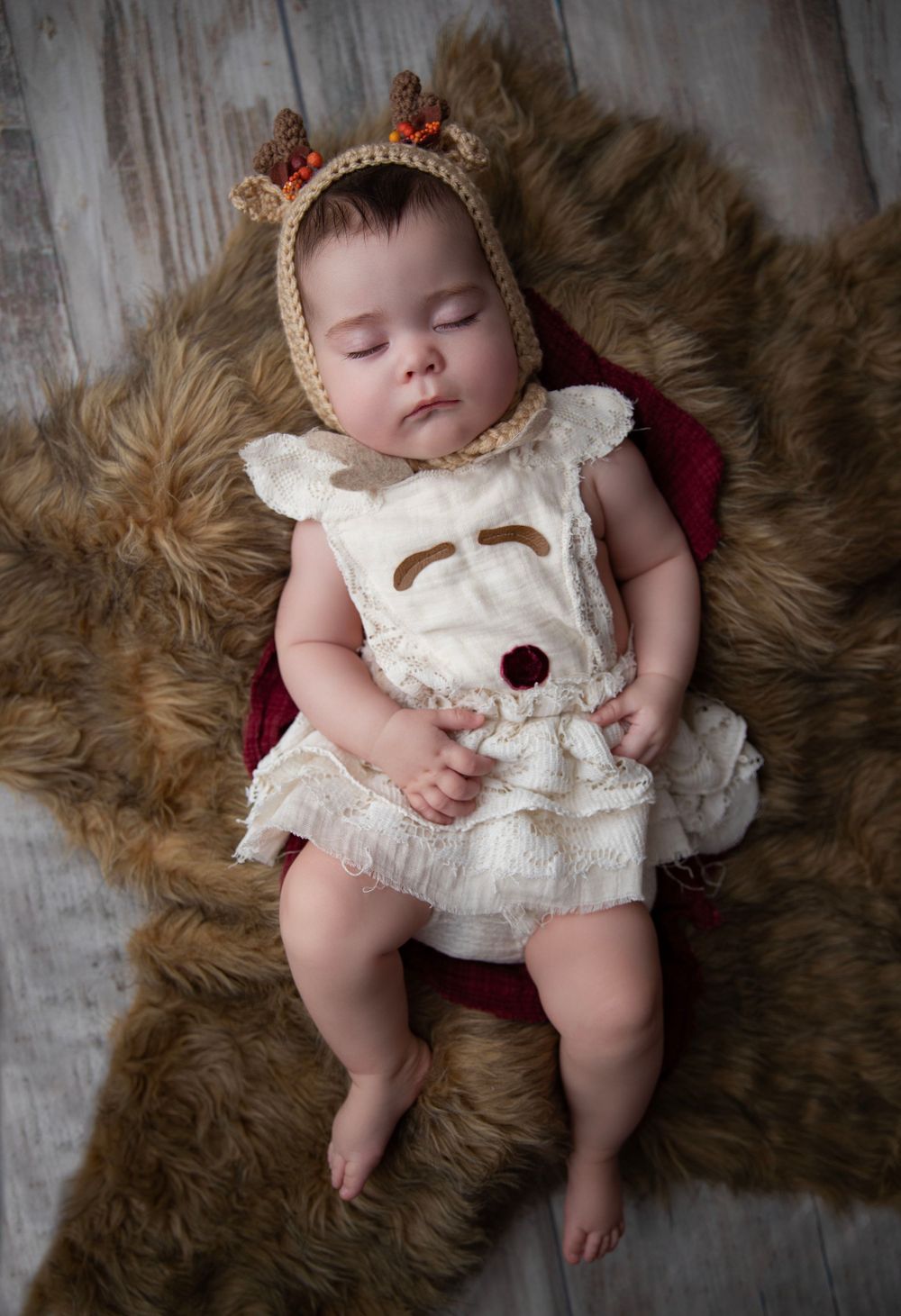 Sleeping newborn in knit outfit during Central Florida newborn photography session.