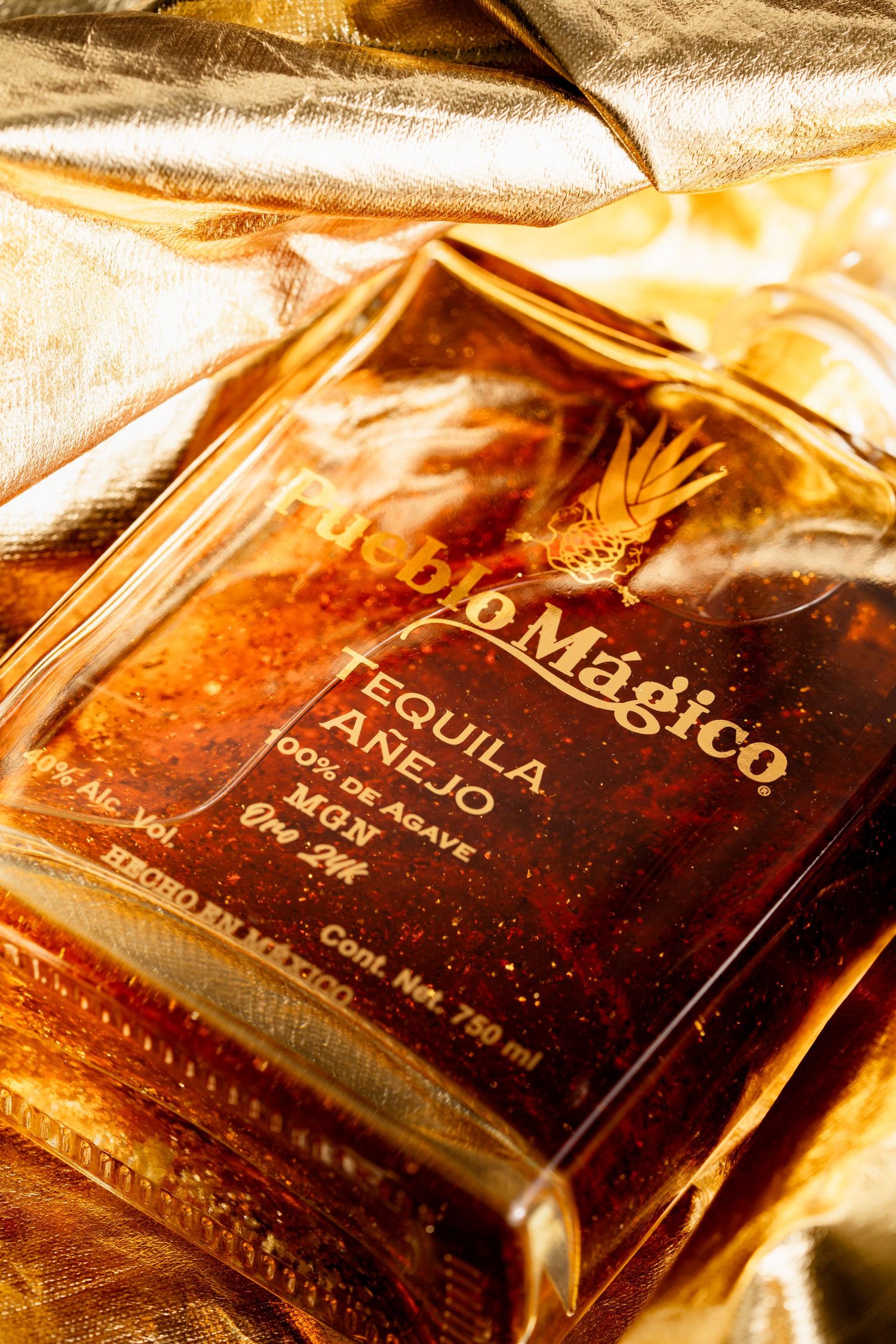 Close-up of premium tequila bottles with golden lighting and aged labels.
