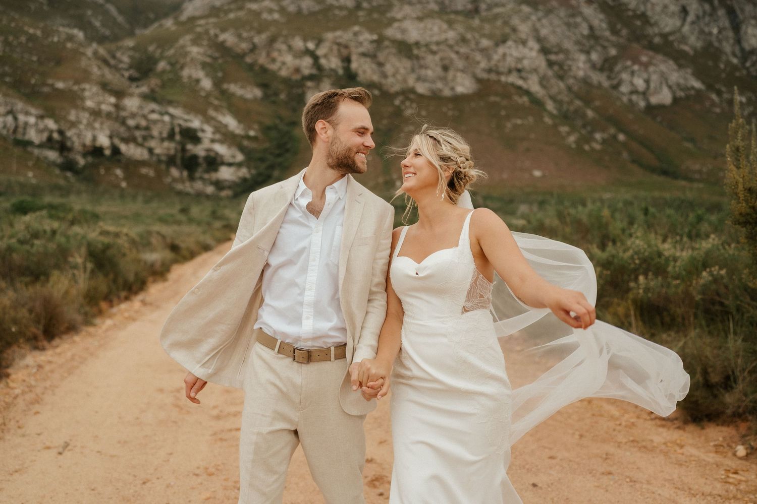 Dancing and twirling on a wilderness trail, the couple celebrates their wedding day among mountains.