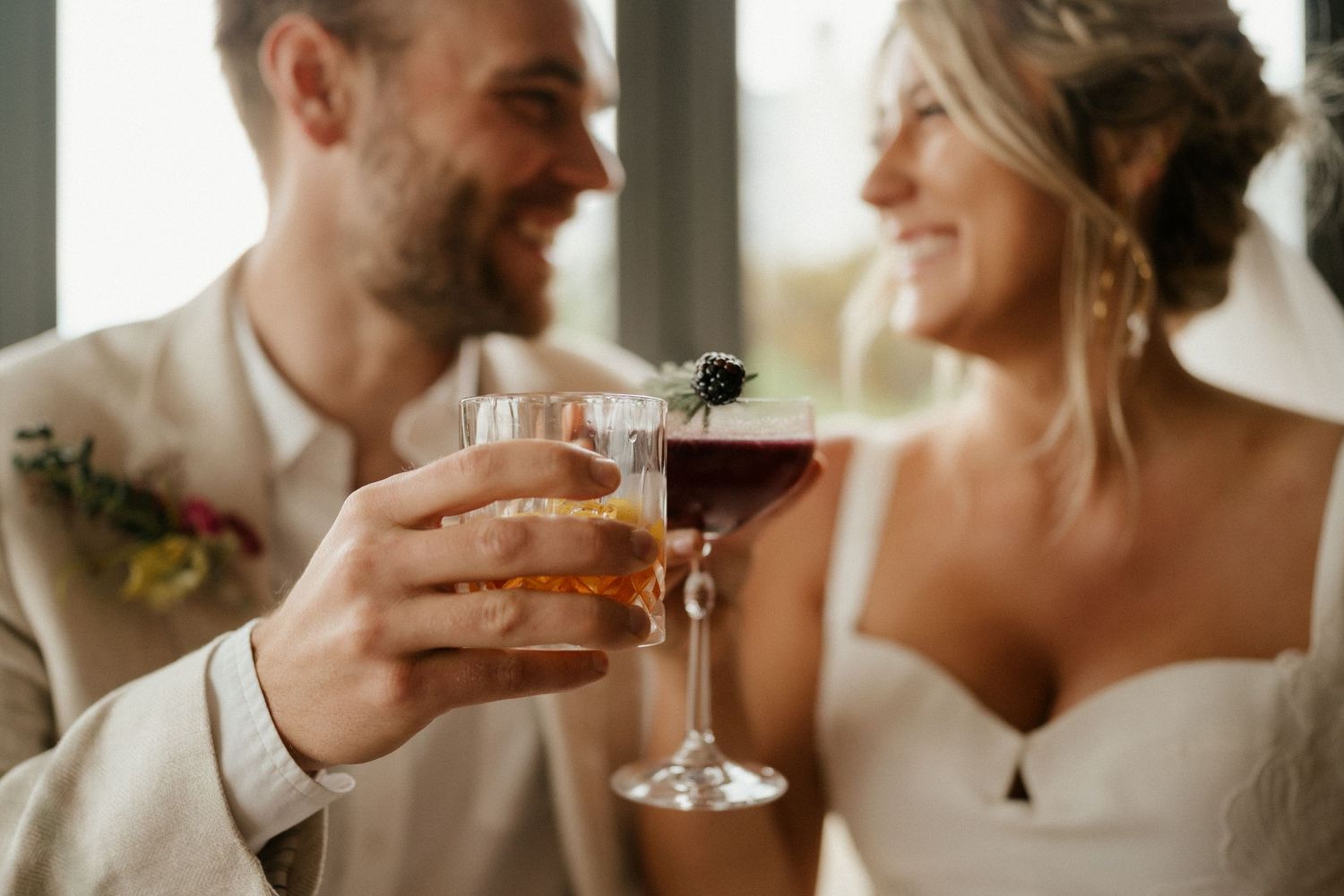 A bride and groom toast with wine glasses during their wedding celebration.
