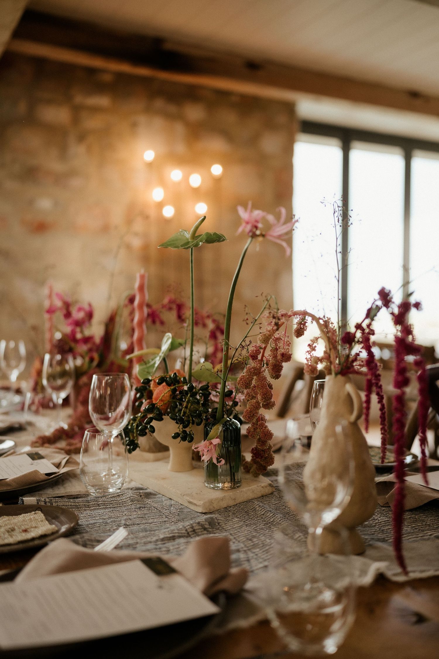 Elegant table setting with pink flowers and decorative bunny figurine for wedding reception.
