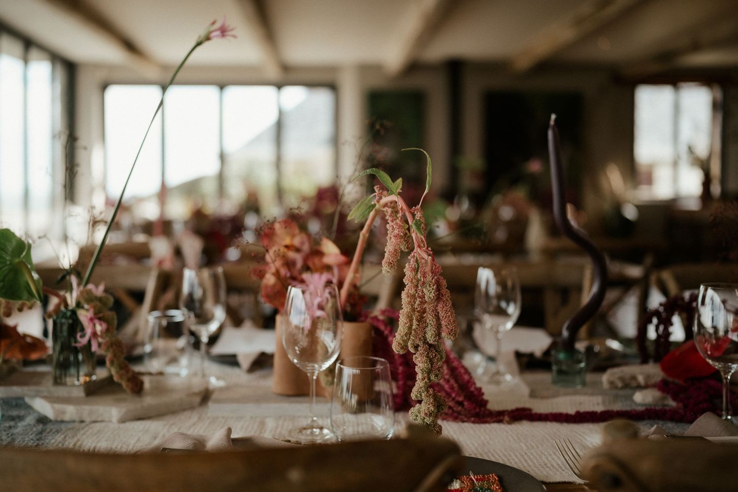 Wedding reception table setting with delicate floral arrangements and soft lighting.