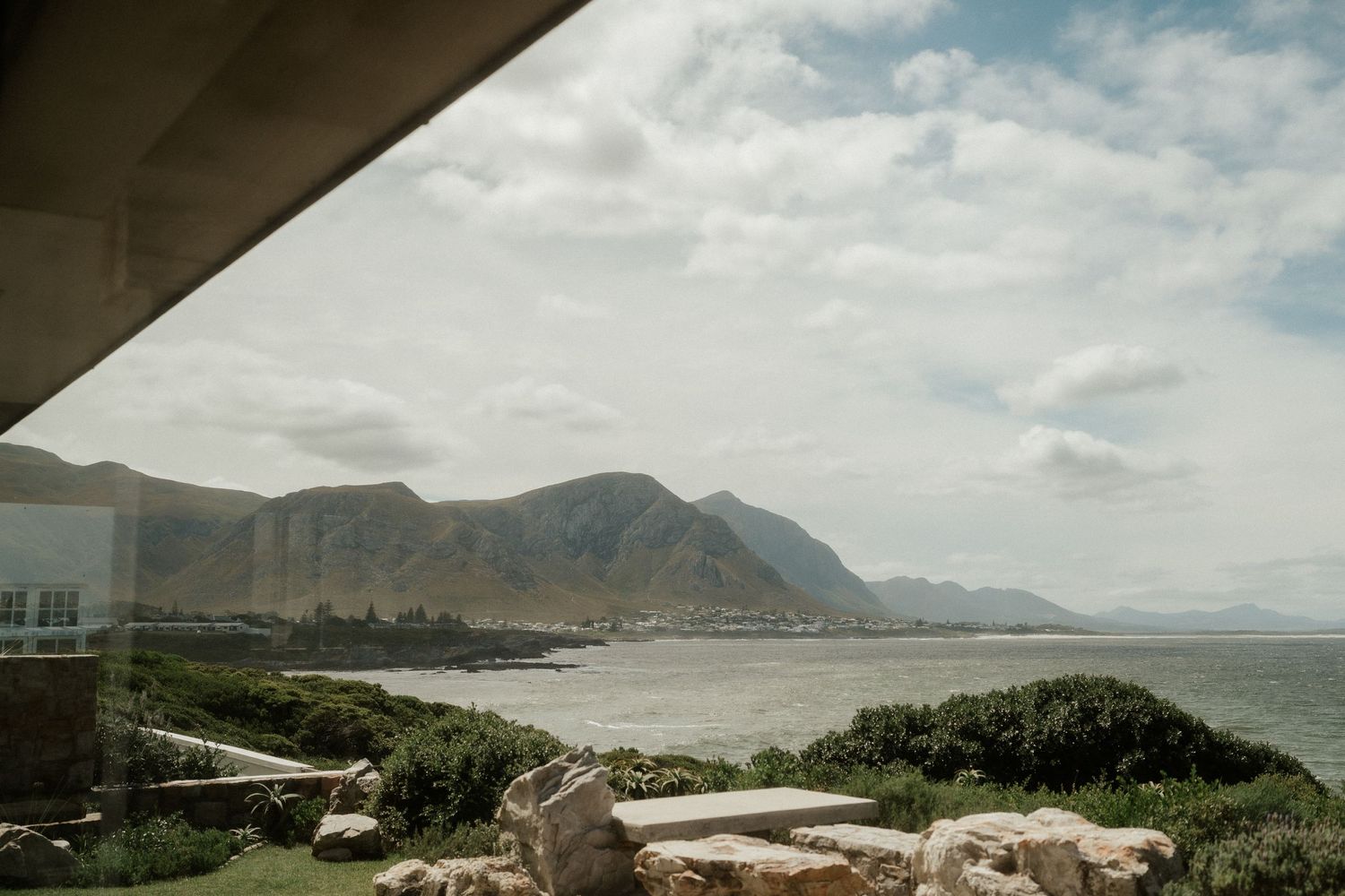 Scenic coastal mountain view captured from under an architectural overhang.