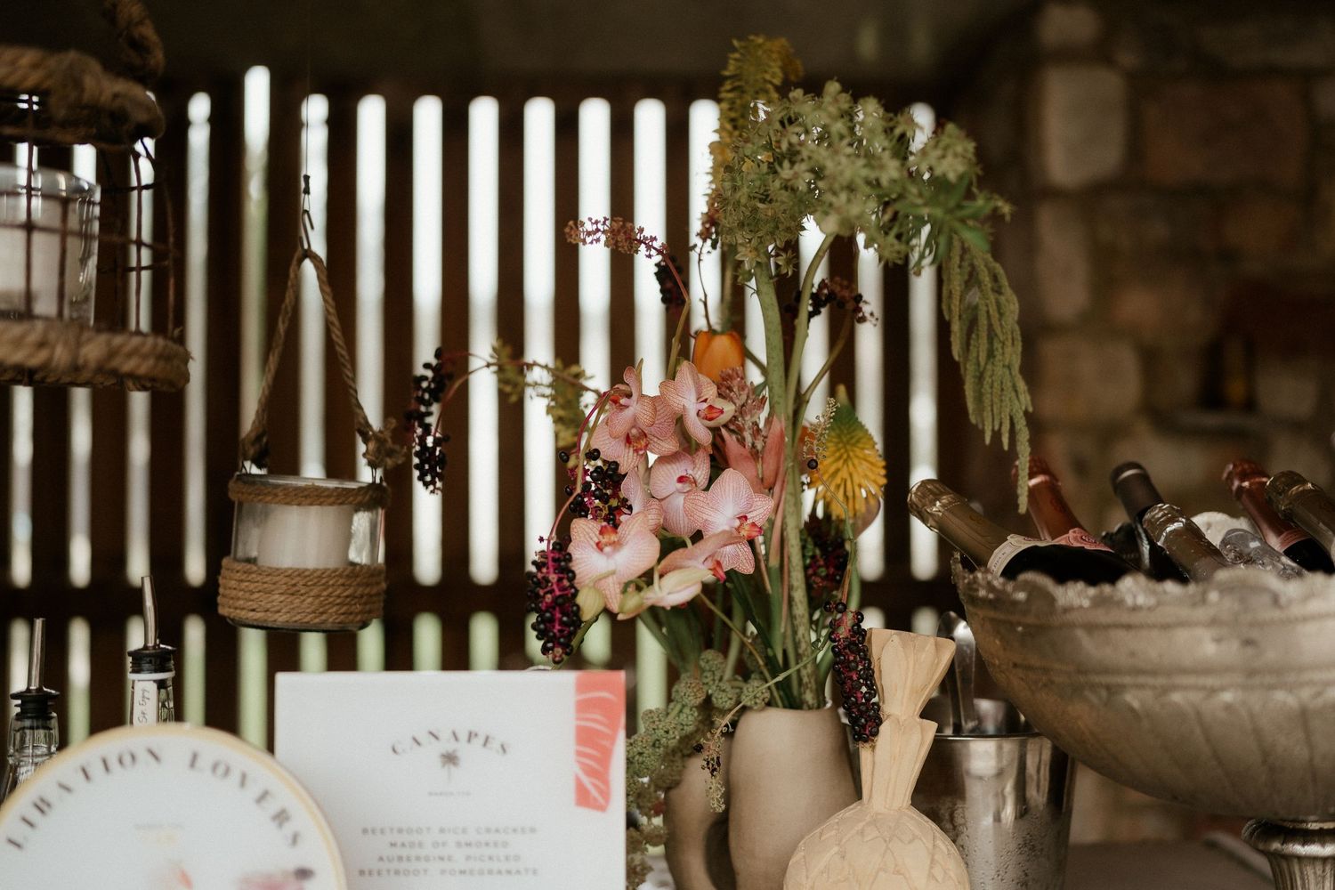Wedding reception decor featuring white candles, delicate floral arrangements, and vintage-inspired table settings.