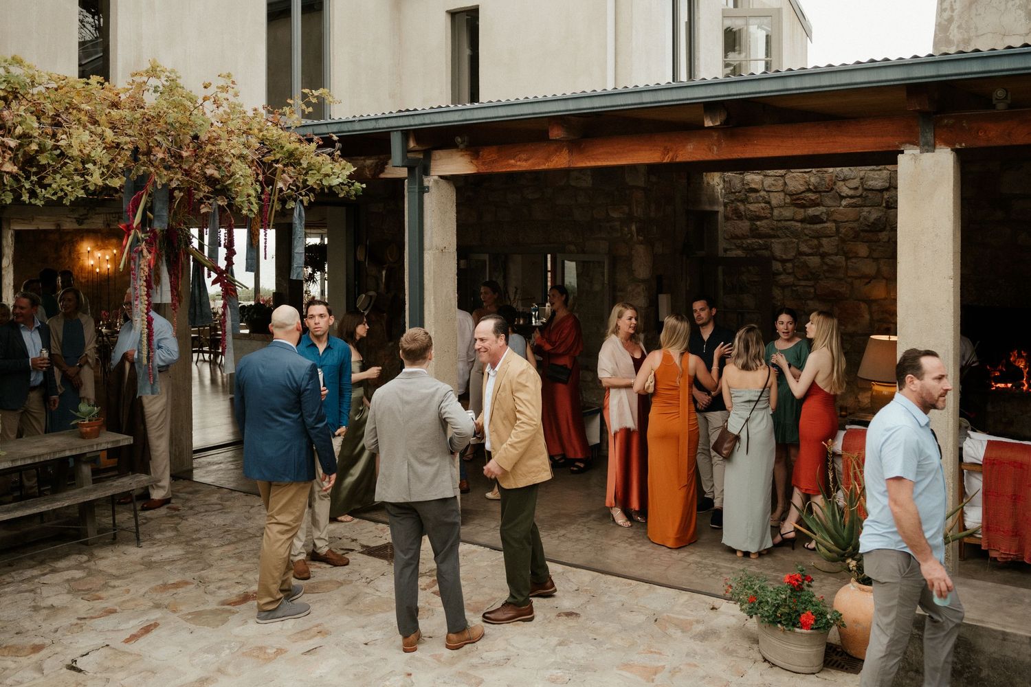 Wedding guests mingling at an outdoor reception venue during a social gathering.