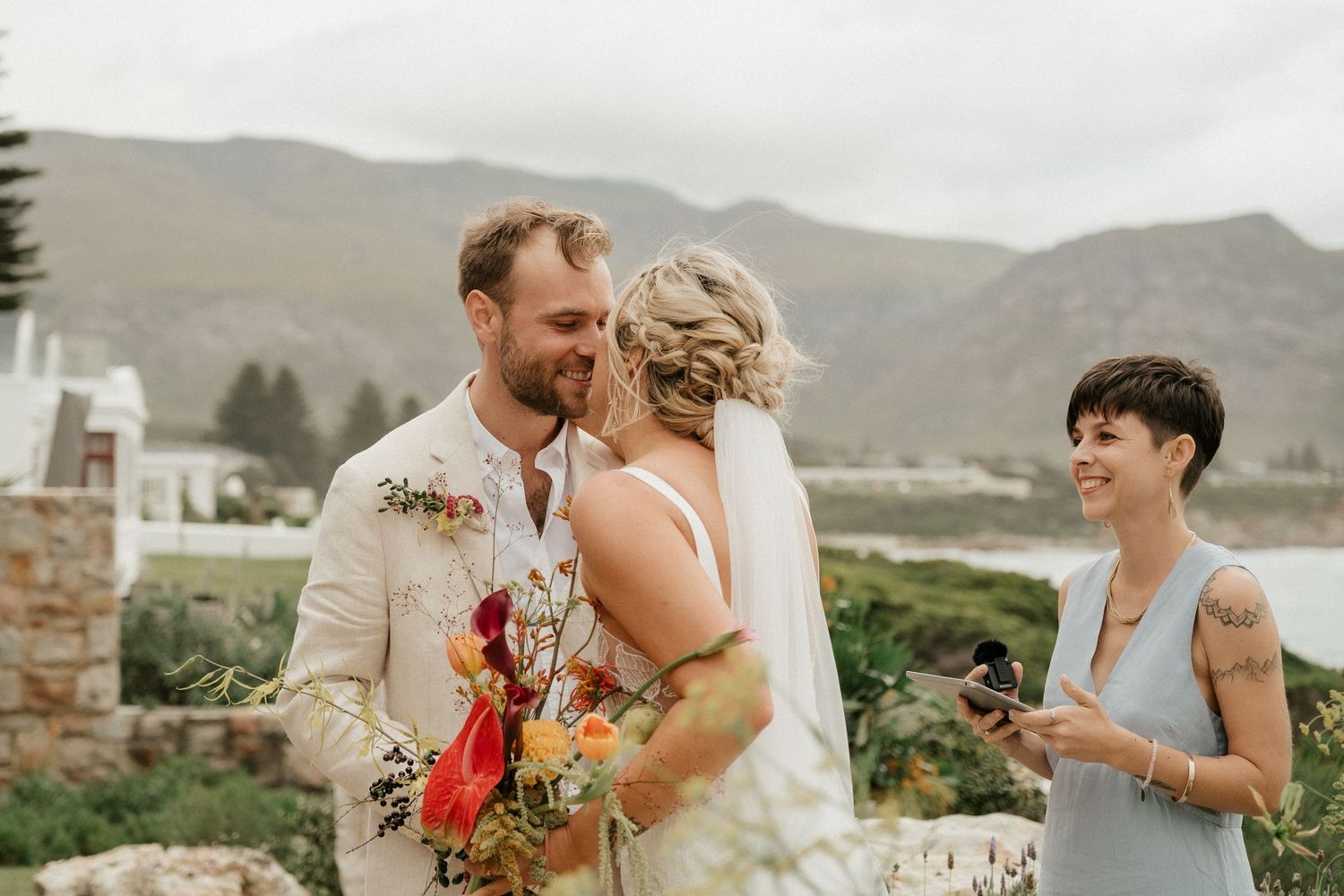 A couple shares an intimate moment during their outdoor mountain wedding ceremony.