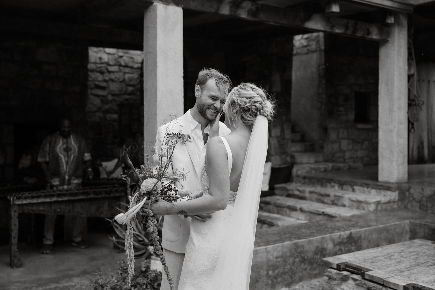 Black and white wedding portrait captured under a covered porch.