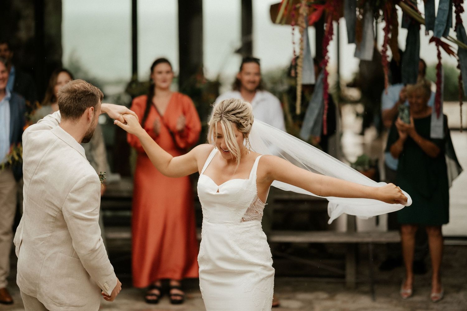 A wedding celebration with guests dancing and moving energetically at the venue.