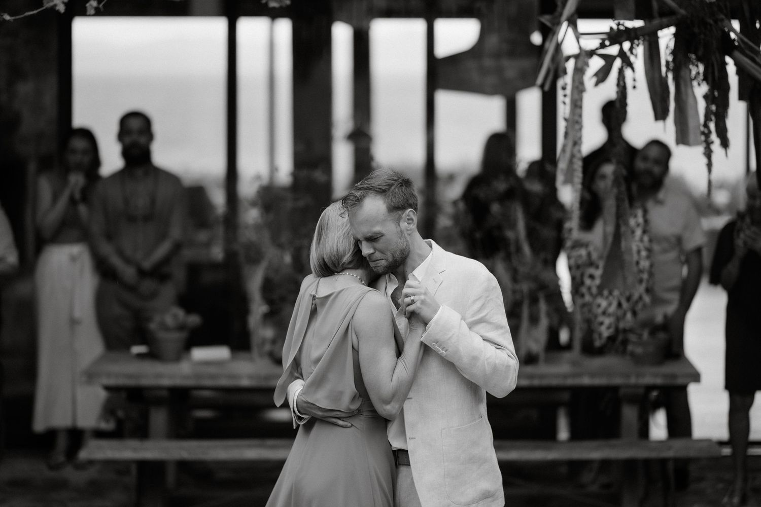 Black and white photo of a romantic dance moment at an outdoor reception.