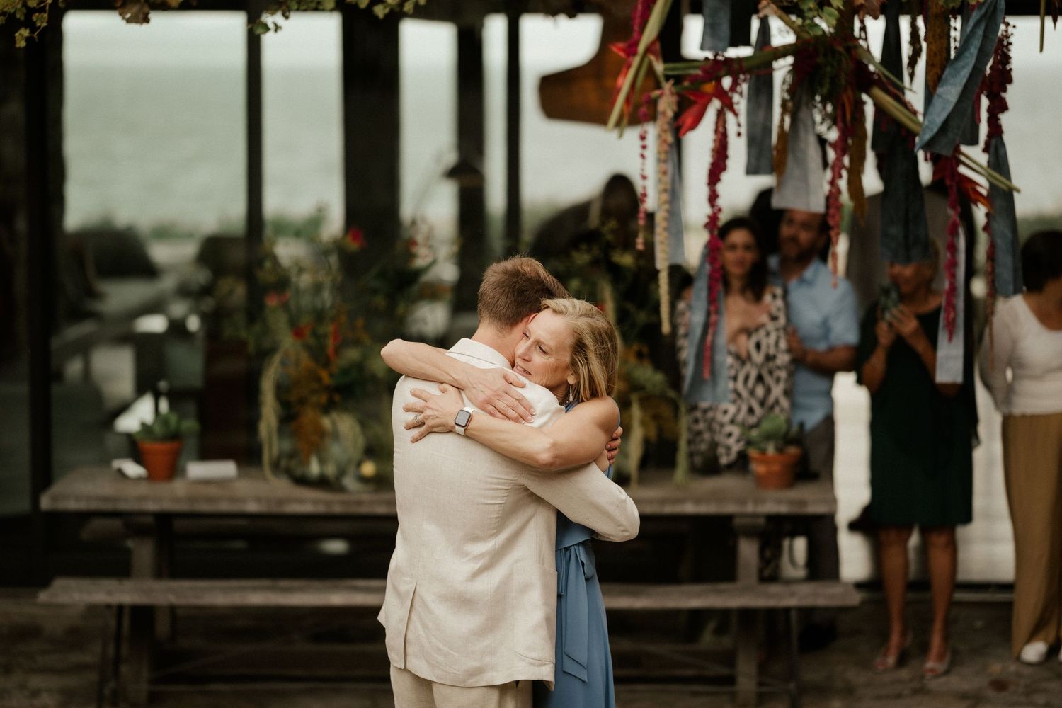 A couple embracing during a dance at an outdoor reception venue.