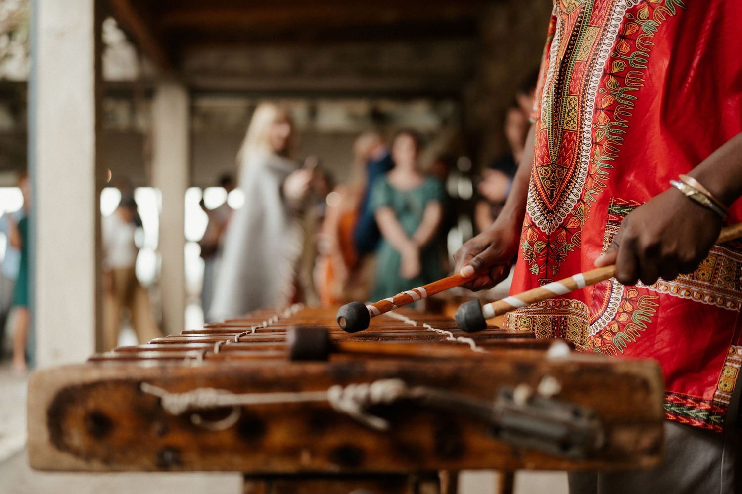 Close-up of traditional wooden musical instruments being played during a wedding ceremony.