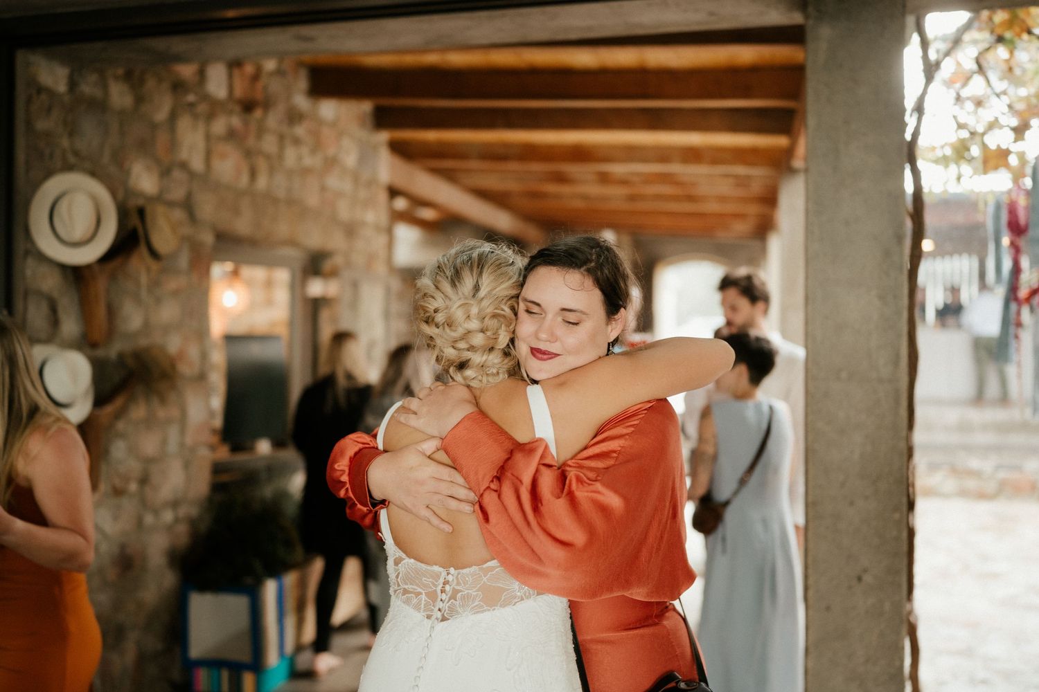 Wedding celebration with joyful embraces and warm emotions shared among guests.