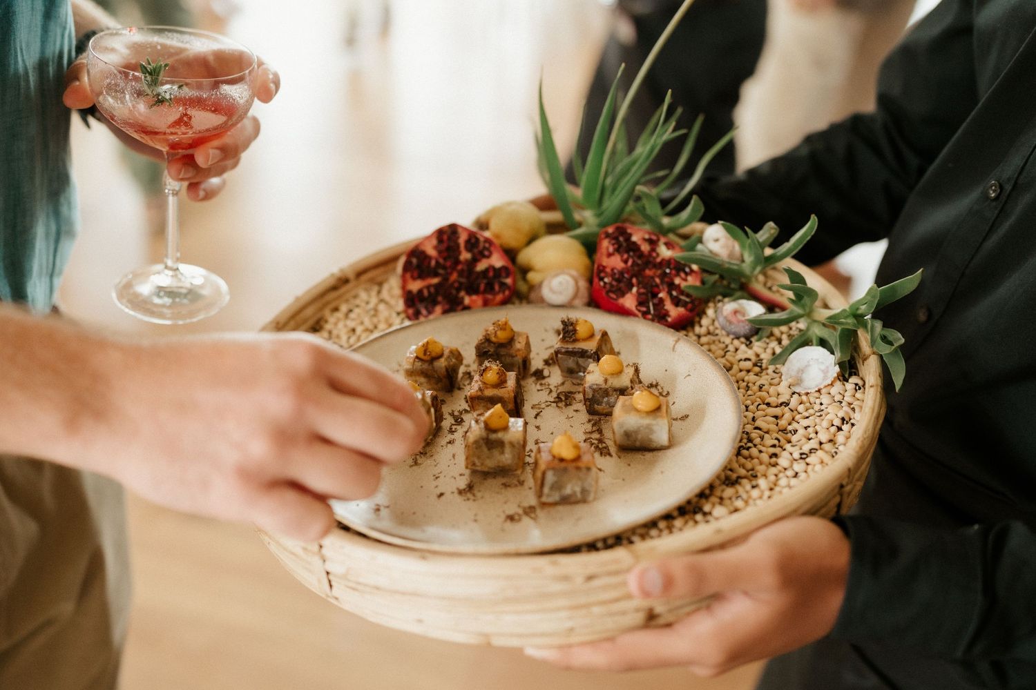 Appetizer plate with grapes and hors d'oeuvres being served at an elegant event.