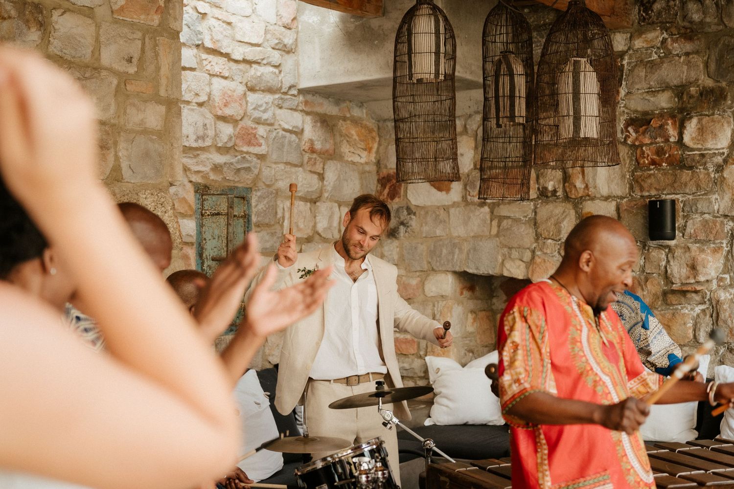 Musicians perform at a rustic stone venue during a lively celebration.