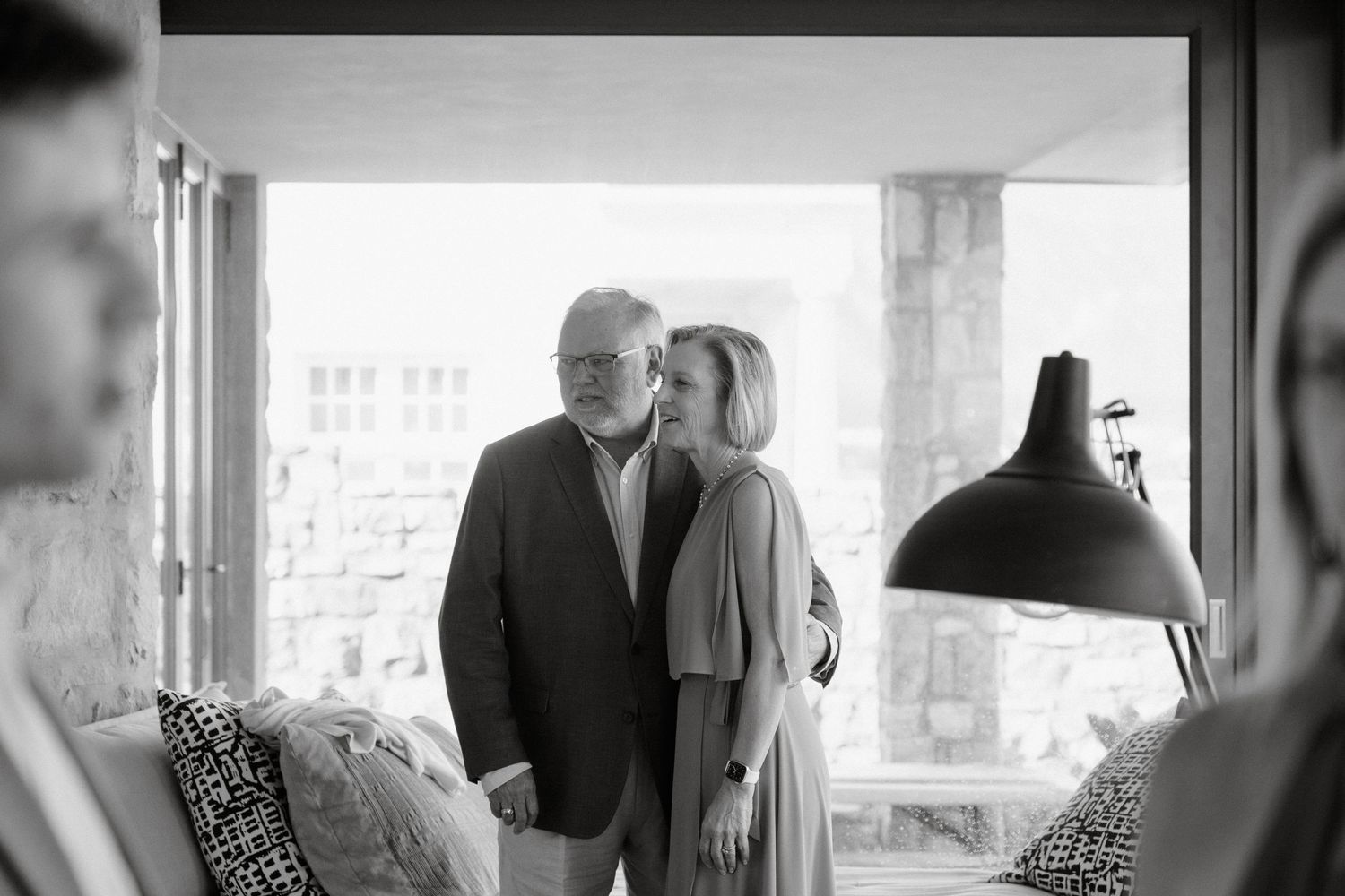 Intimate black and white portrait captured near a window with natural light.