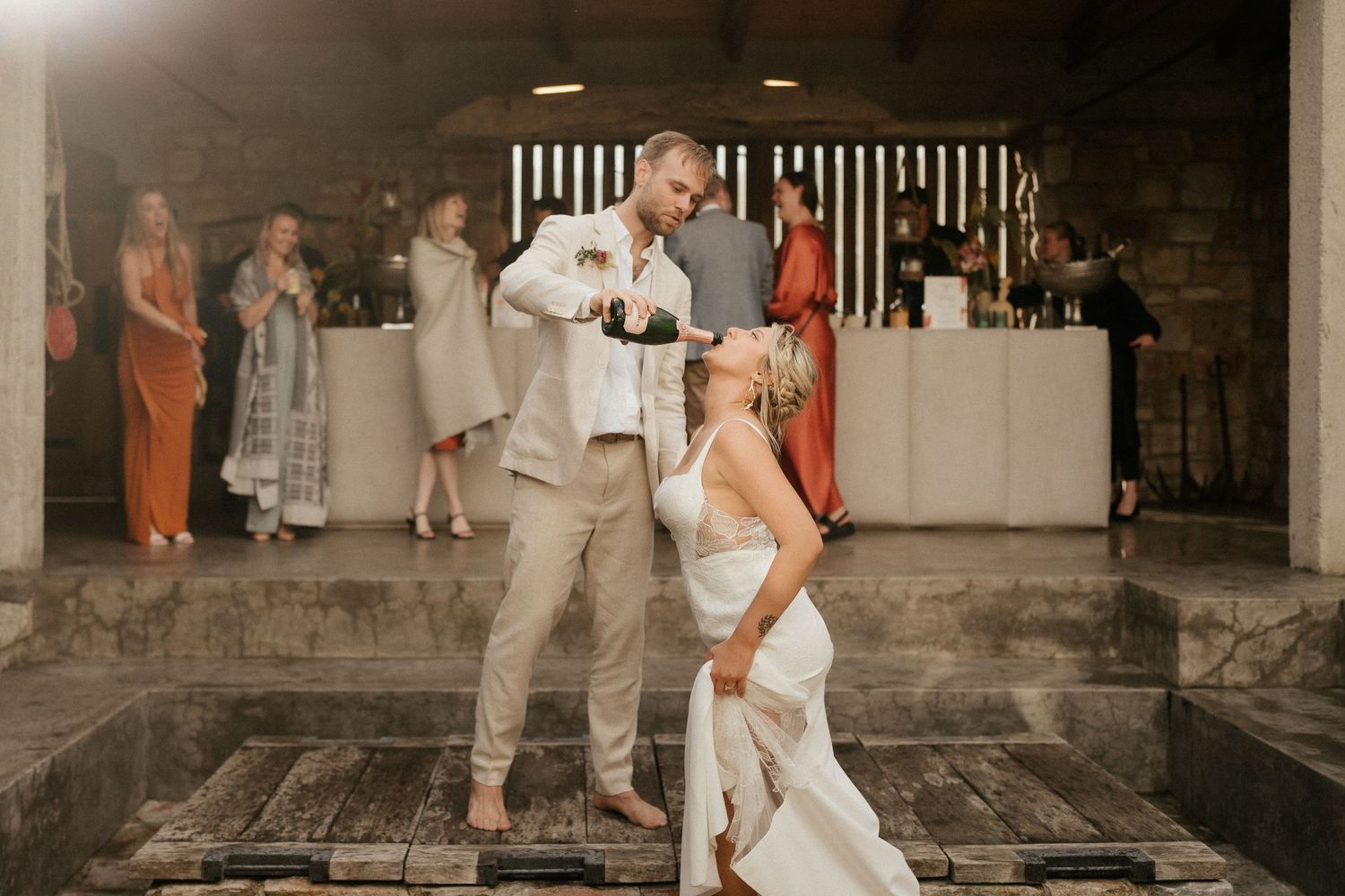 Wedding celebration on a covered patio with guests dancing and enjoying festivities.