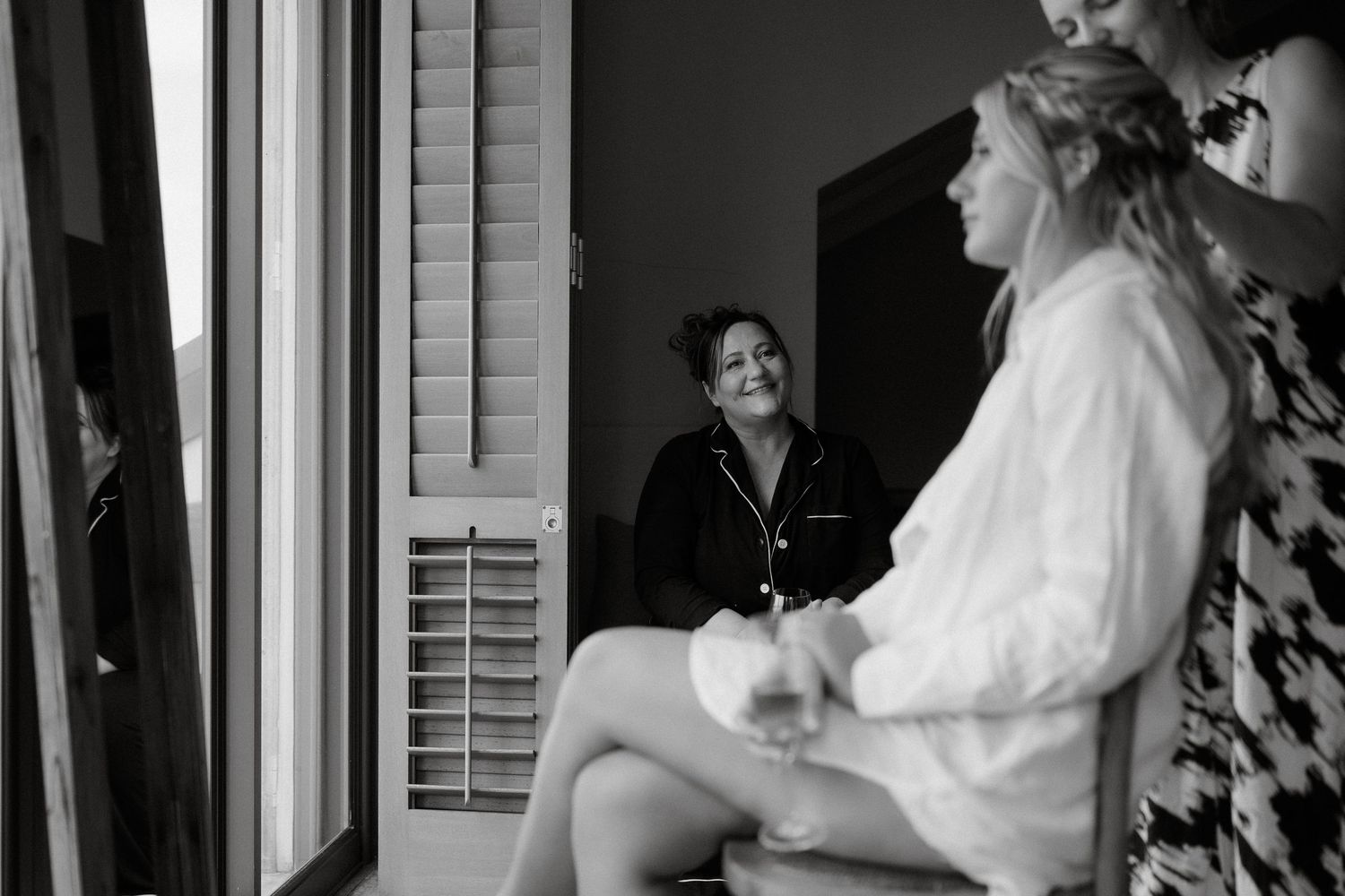 A black and white photo showing getting ready moments before a wedding ceremony.