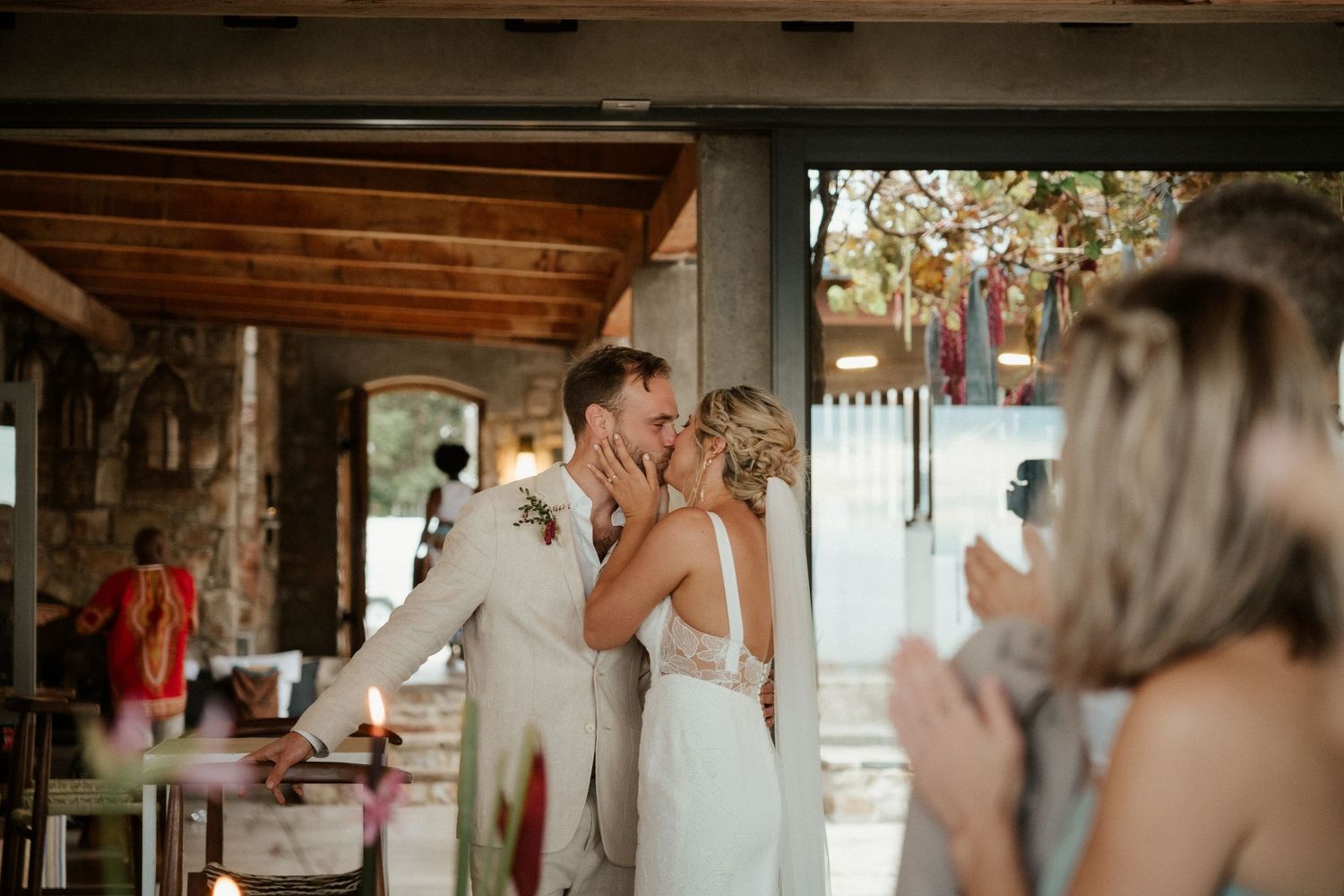 Couple shares a joyful moment during their outdoor wedding reception.