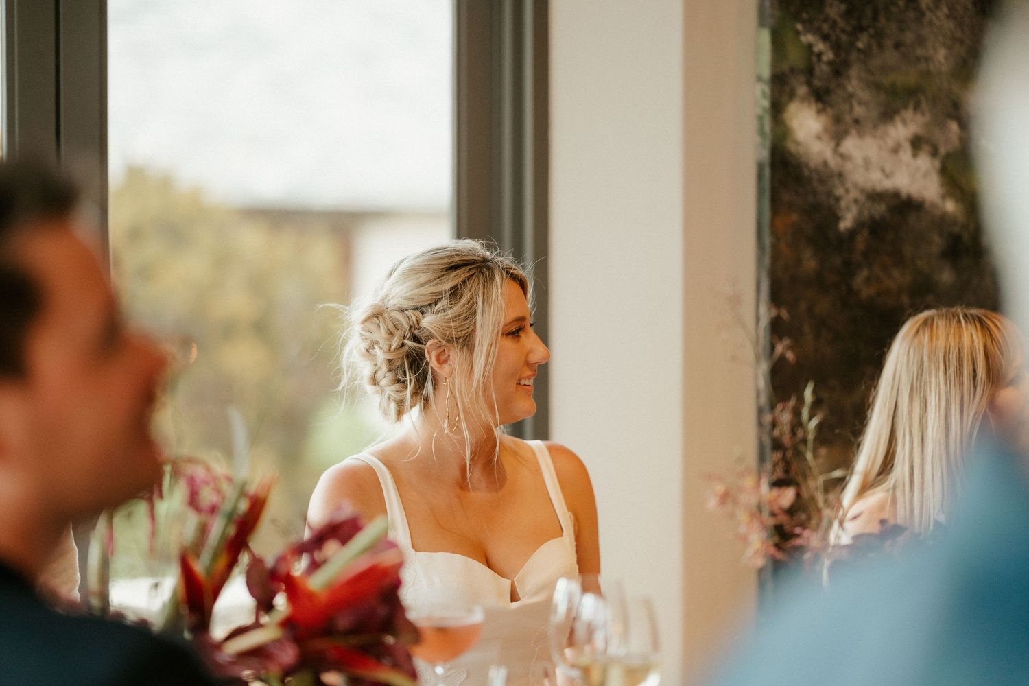 A candid reception moment showing joyful laughter during wedding celebrations.