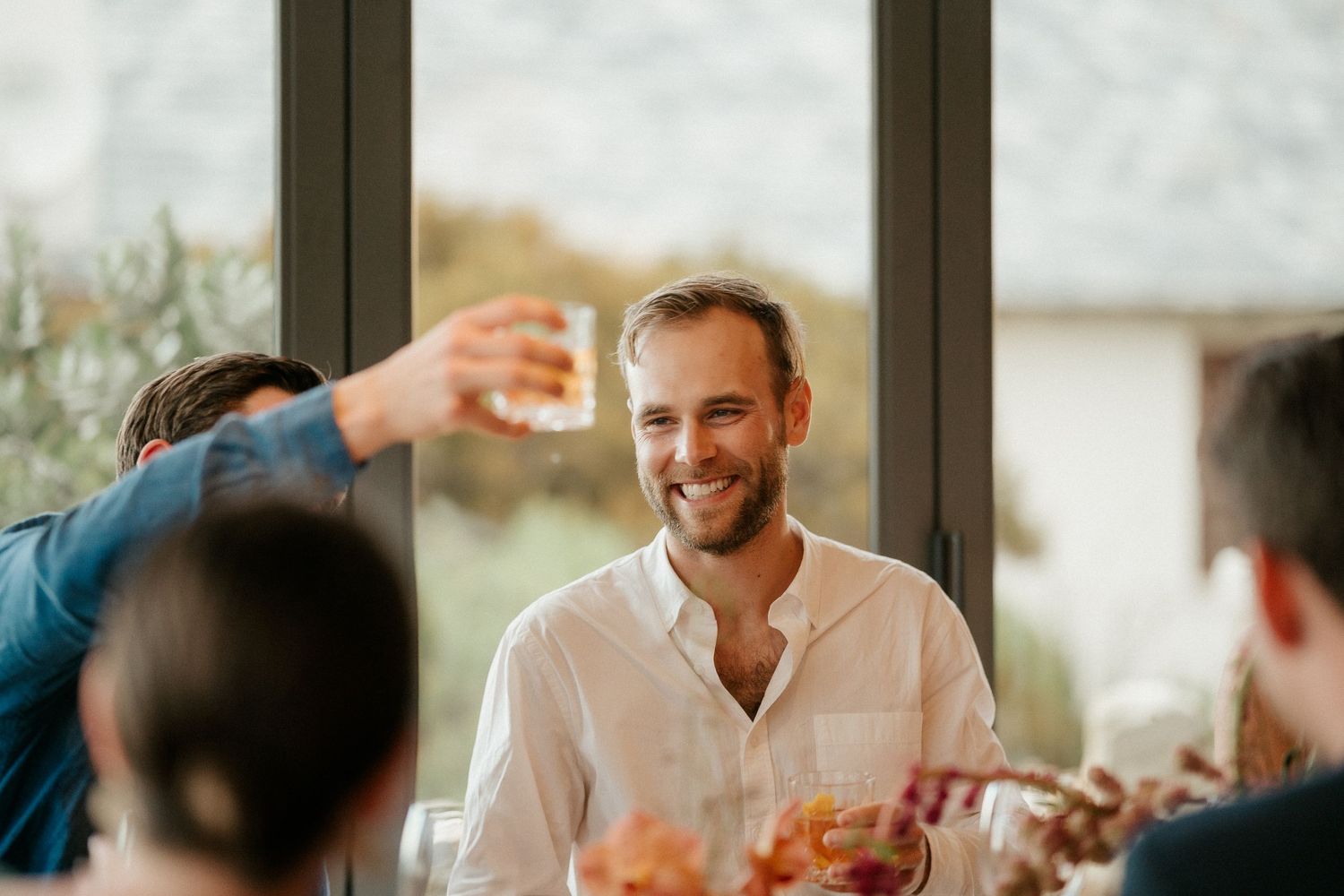 Guests enjoy drinks and conversation during an elegant indoor wedding reception.