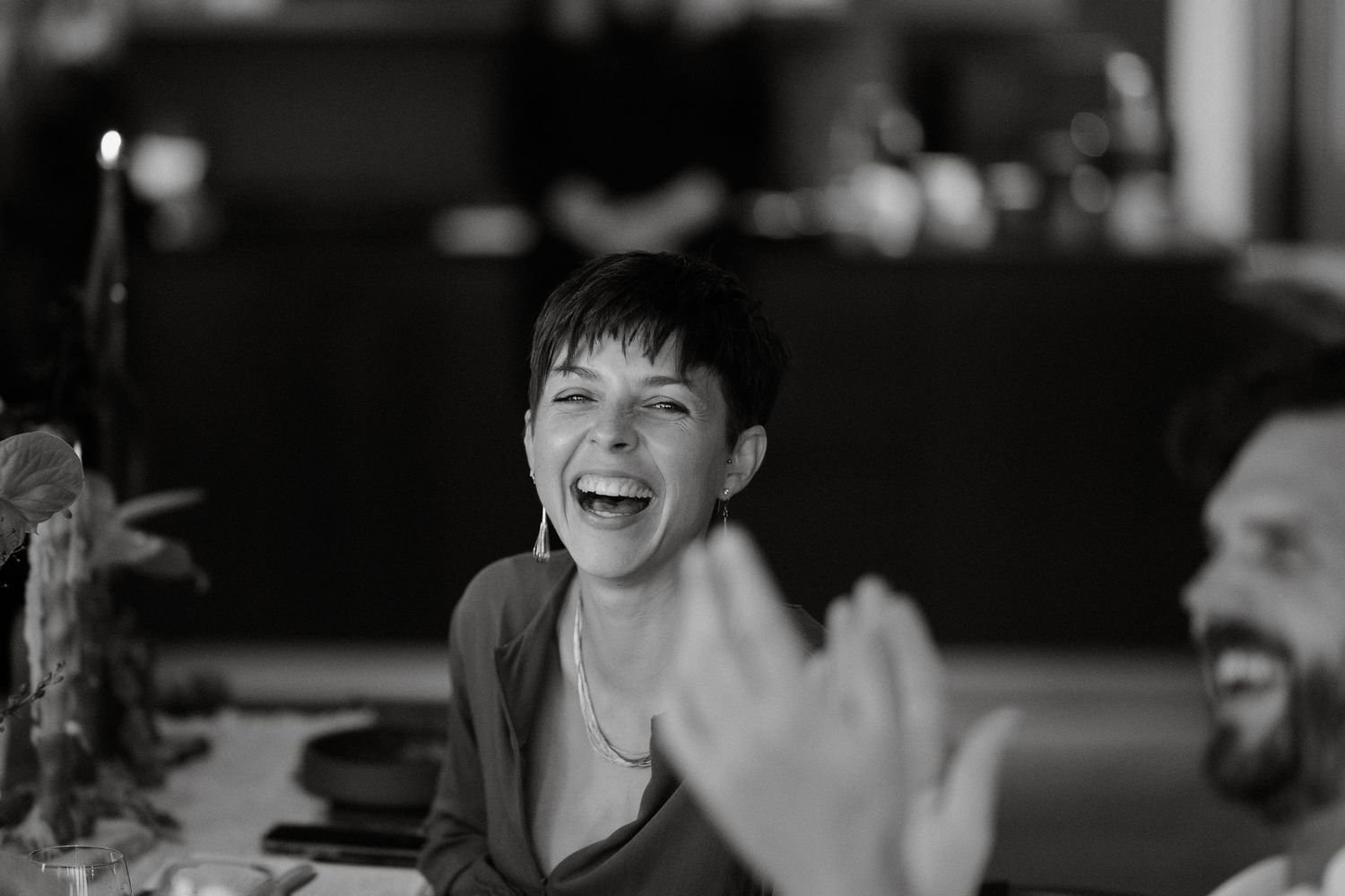 A joyful candid moment captured during a celebration in black and white.