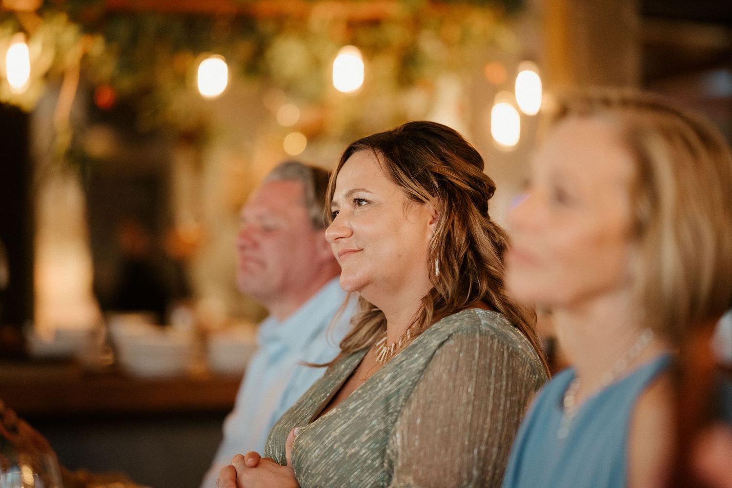 Guests enjoying a celebratory moment in a cozy restaurant setting with warm ambient lighting.
