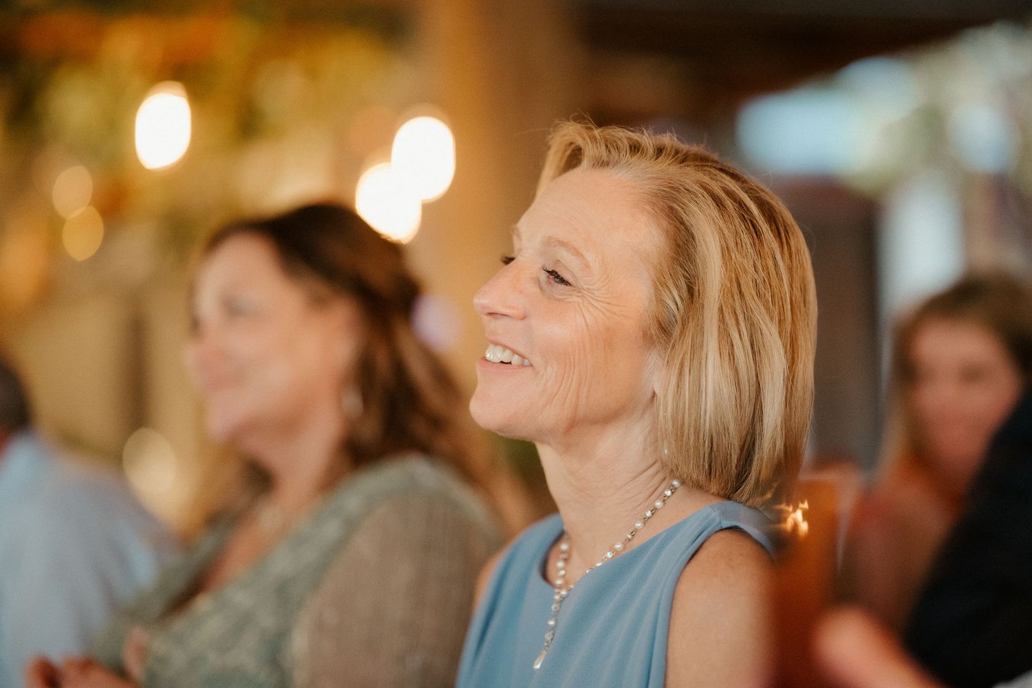 A candlelit celebration scene with soft bokeh lighting effects in the background.