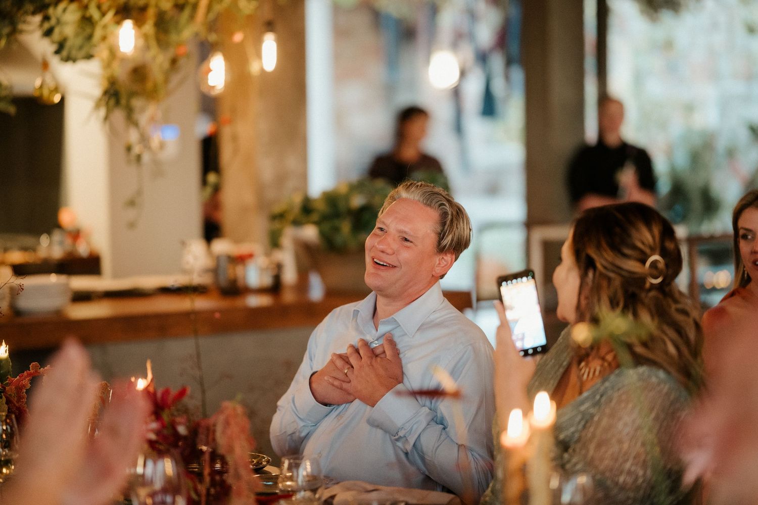 An emotional moment during a candlelit dinner celebration.