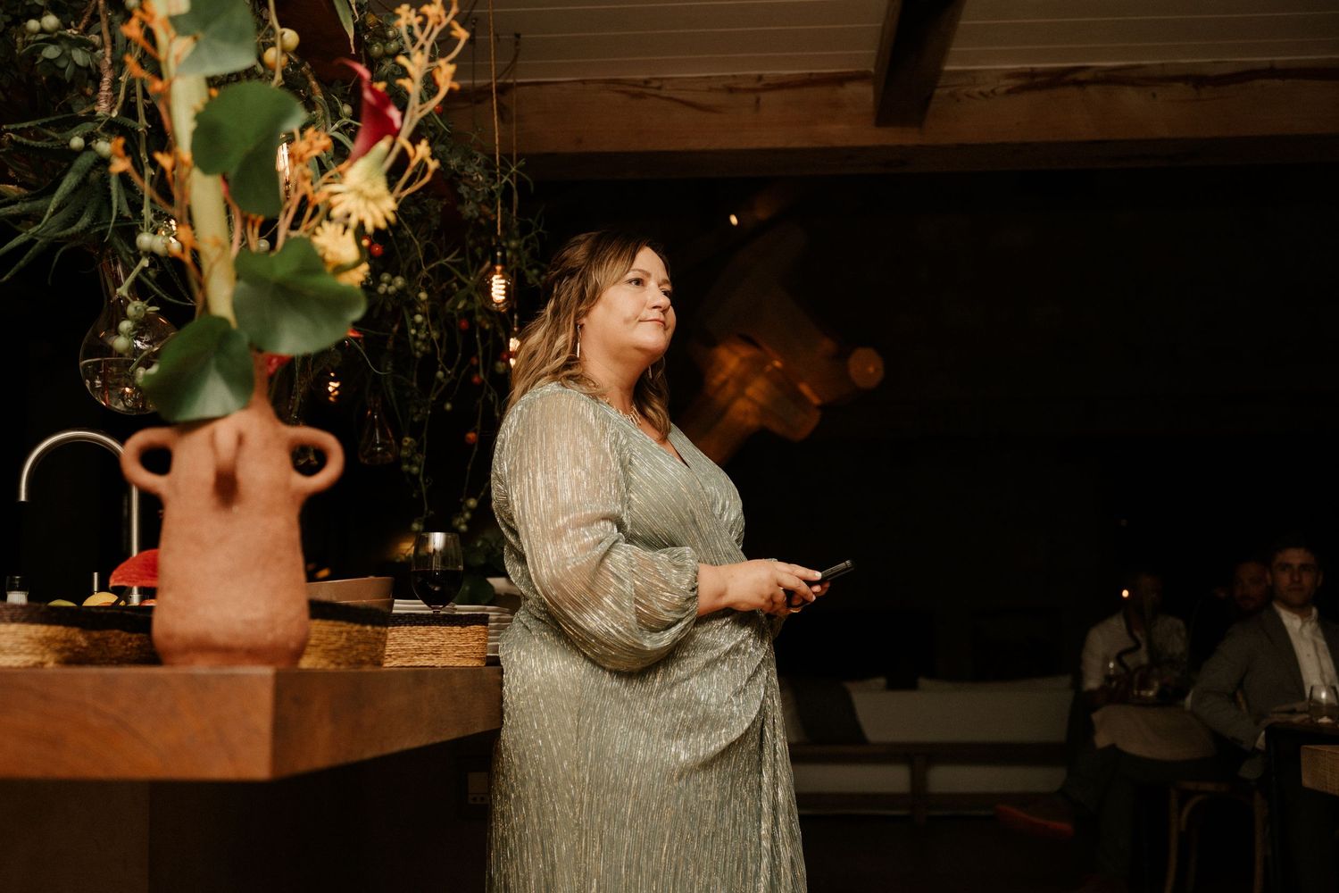 A glittering scene at an evening wedding reception with a sparkly dress and ambient lighting.