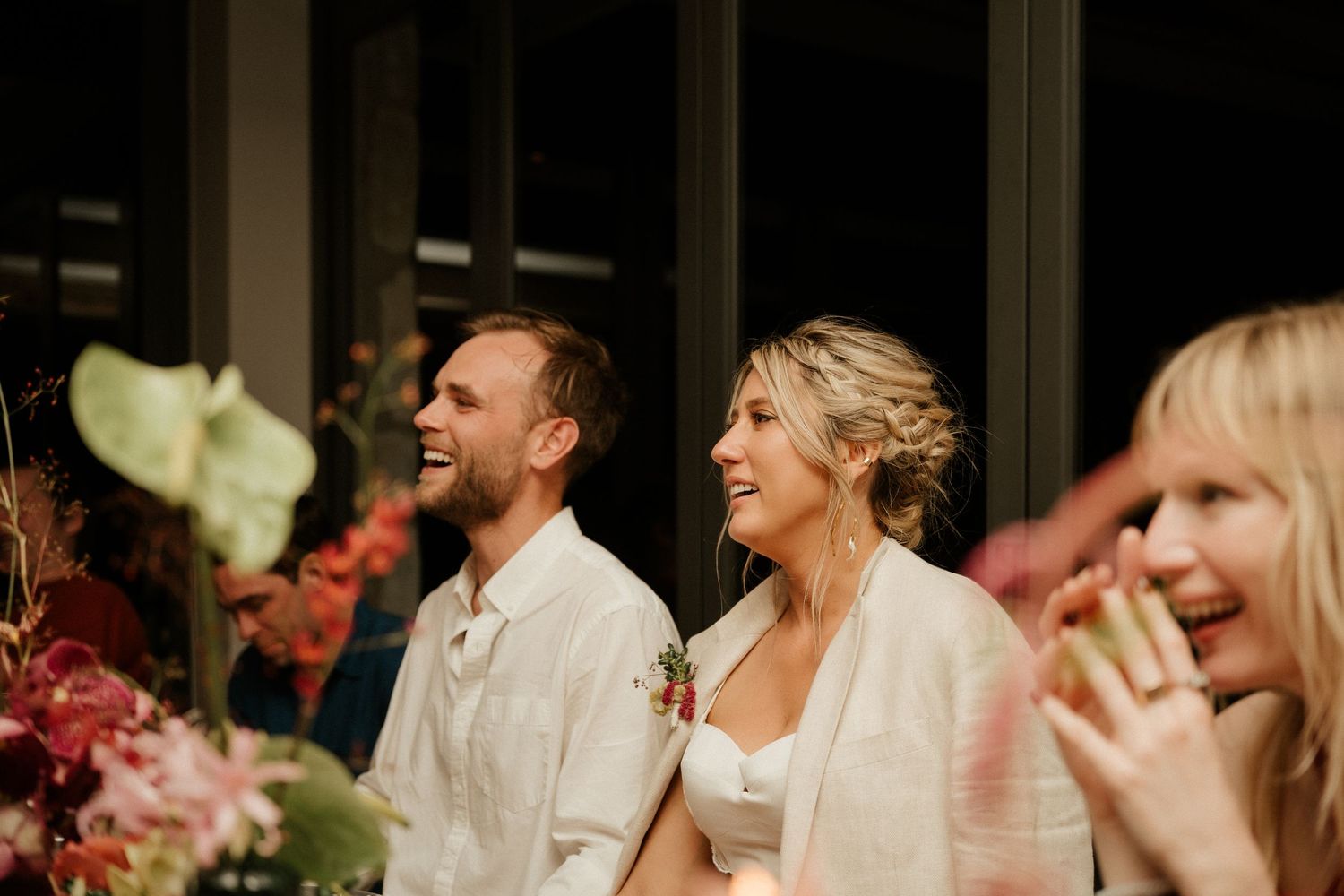 Wedding guests share laughs and smiles during the reception dinner.