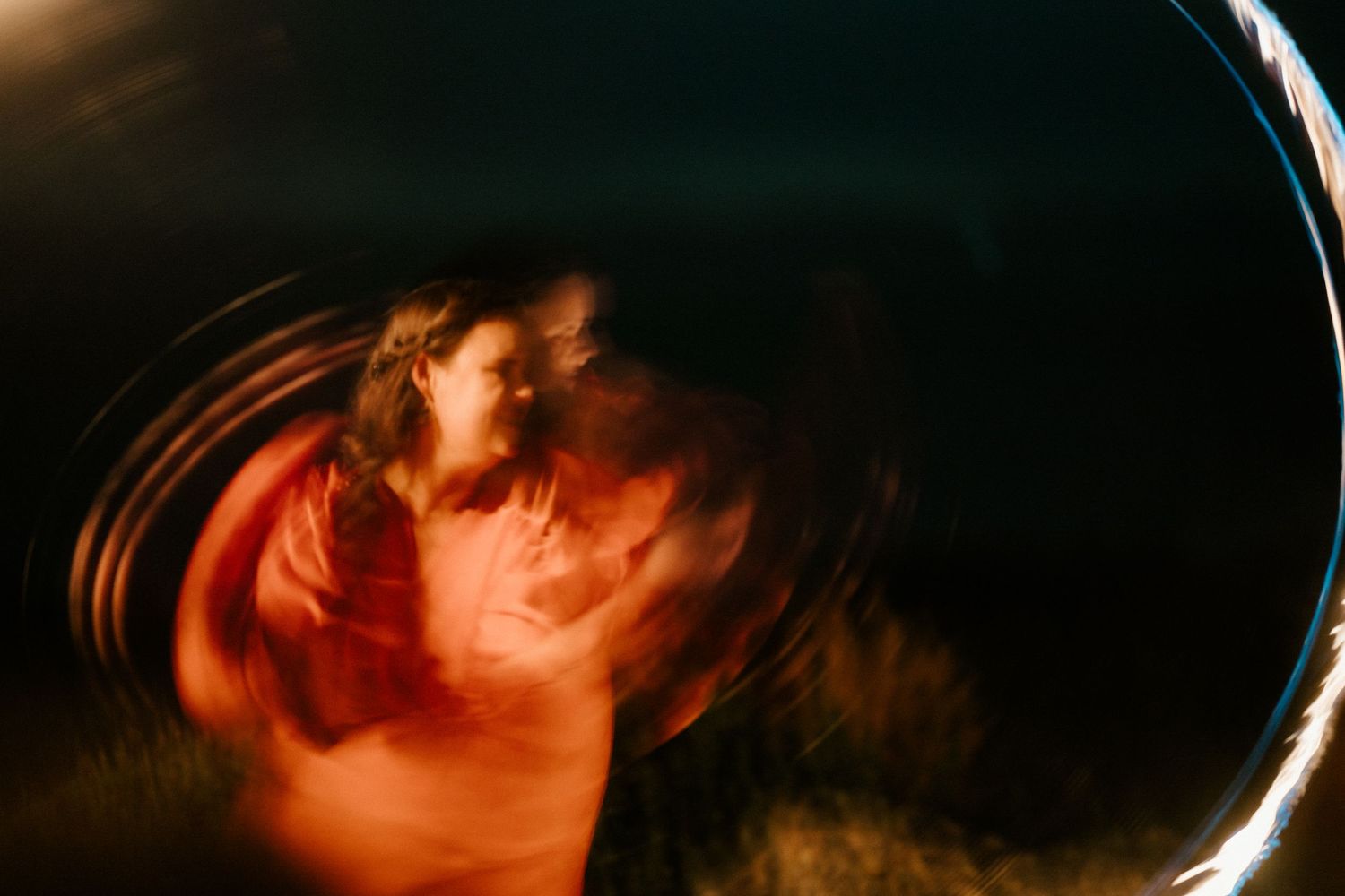 An artistic motion-blur photo with warm orange tones creates an abstract swirling effect.