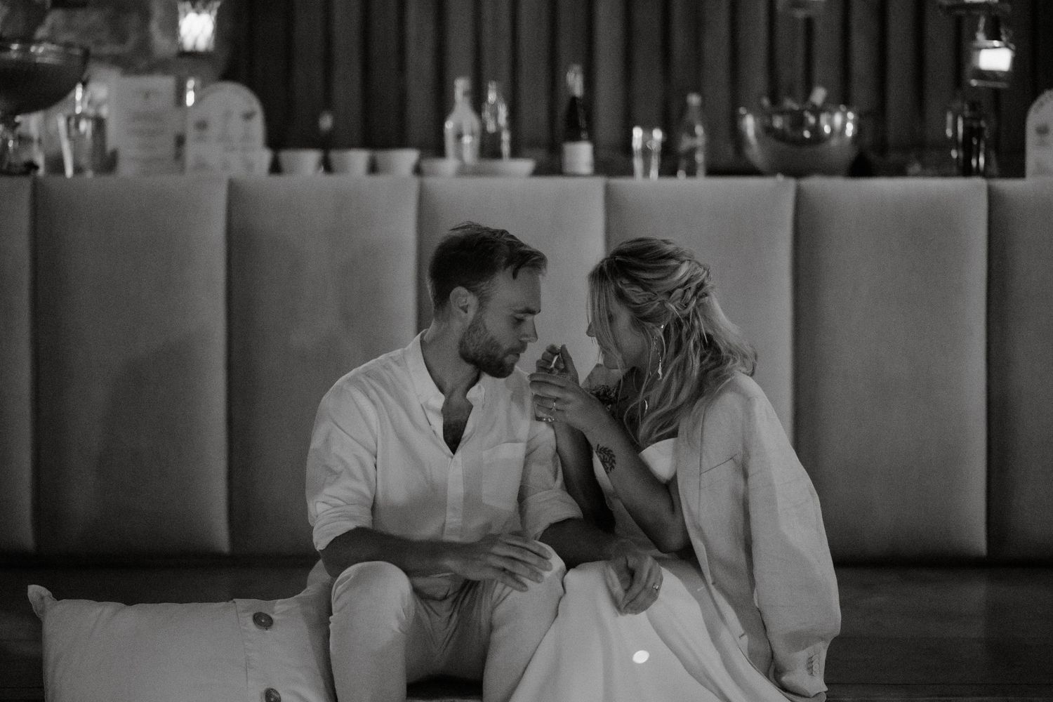 A romantic moment captured in black and white at an evening reception.
