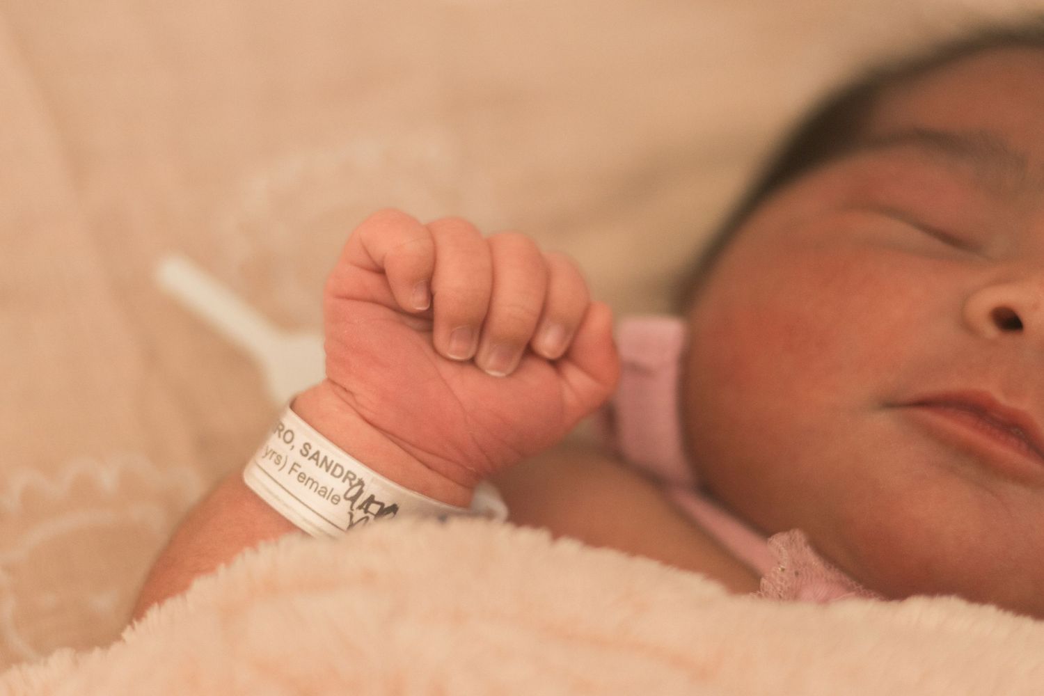 Close-up view of hospital identification bands and medical equipment in a clinical setting.