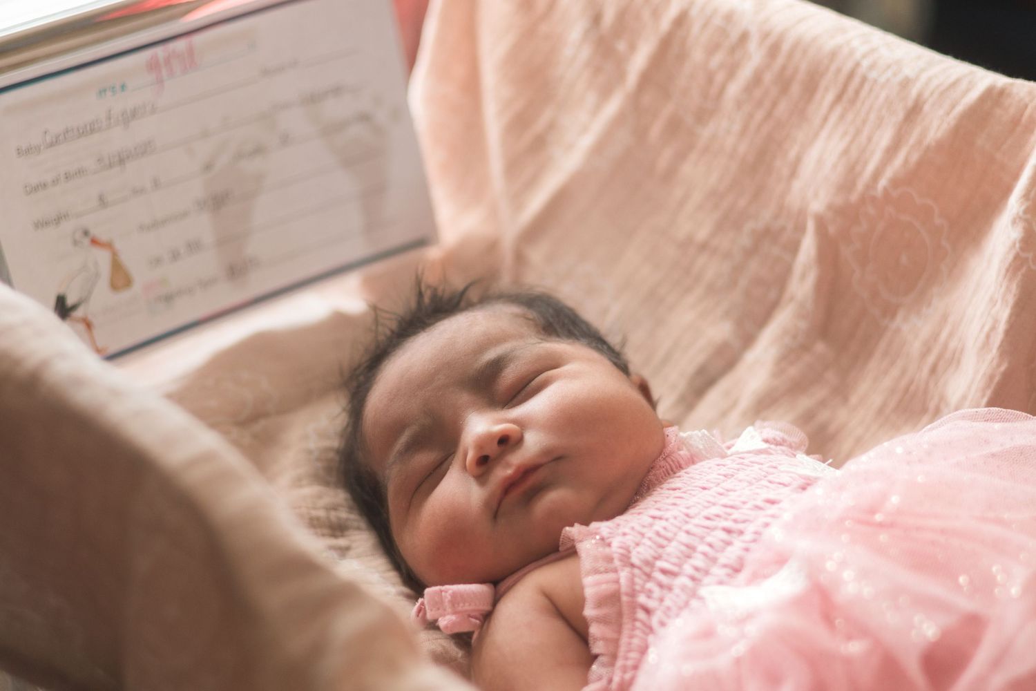 A series of heartwarming moments captured between parent and newborn baby in a hospital setting.