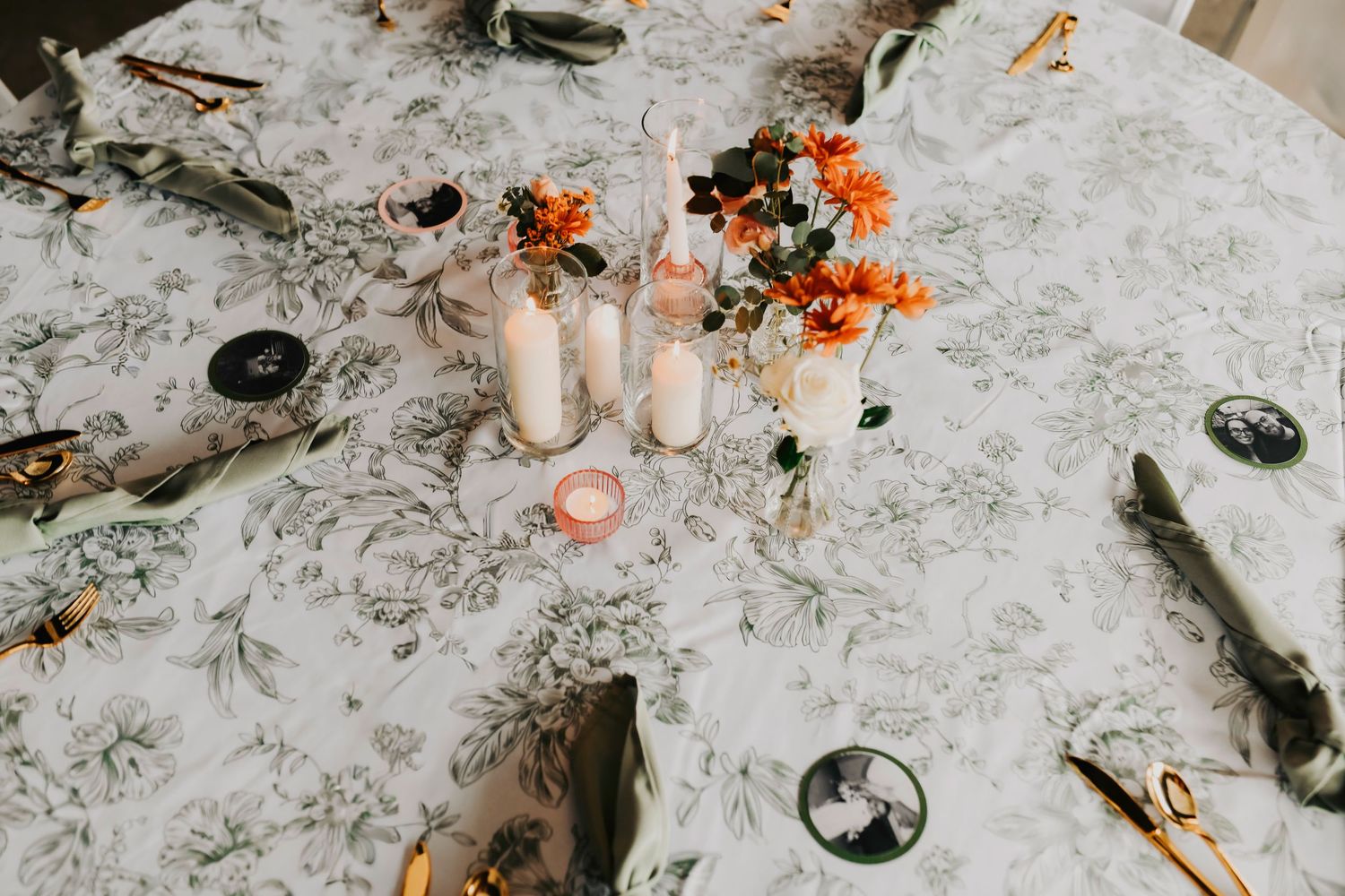 a green botanical linen tabletop with fall romantic center pieces
