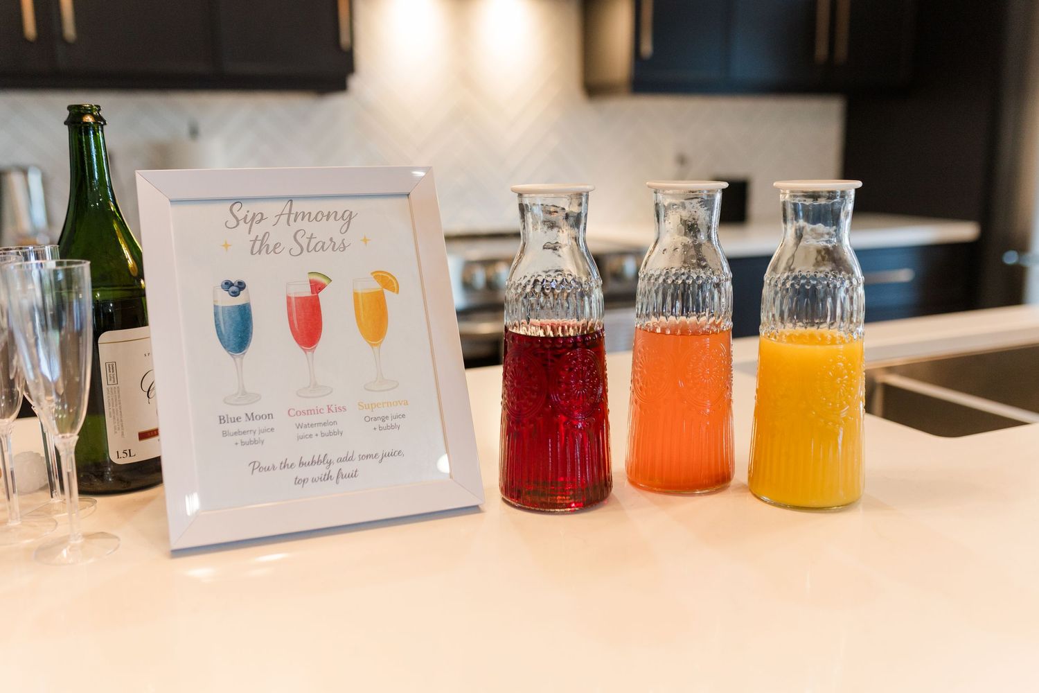 Colorful cocktail mixers and glass bottles arranged on a bar counter with menu signs and ambient lighting.