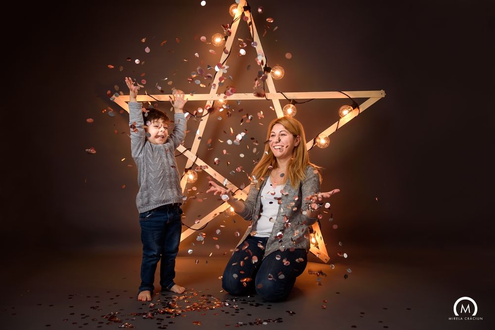 A large illuminated wooden star decoration creates a warm glow against a dark background.