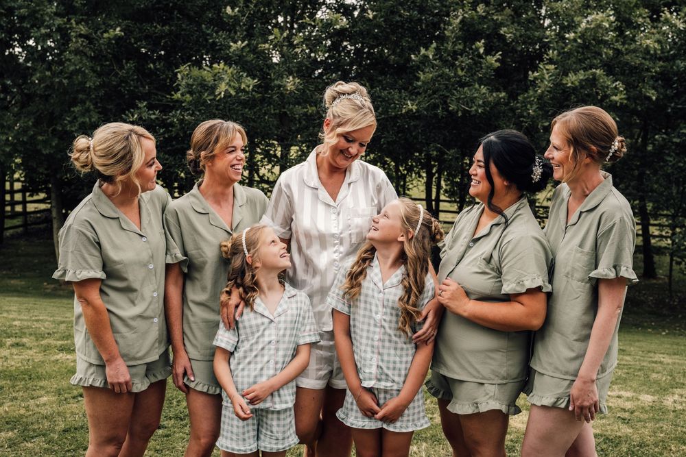 Casual outdoor group photo with matching outfits in a garden setting.