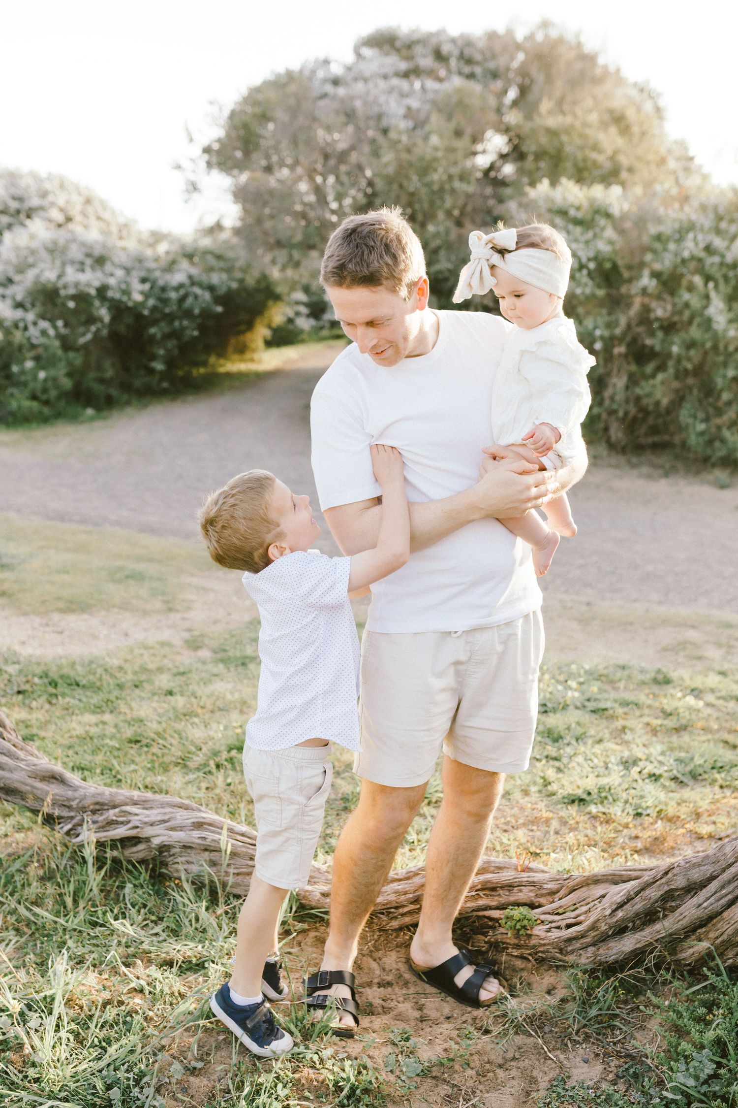 Three candid lifestyle photos showing sweet moments between family members wearing white and beige outfits outdoors.