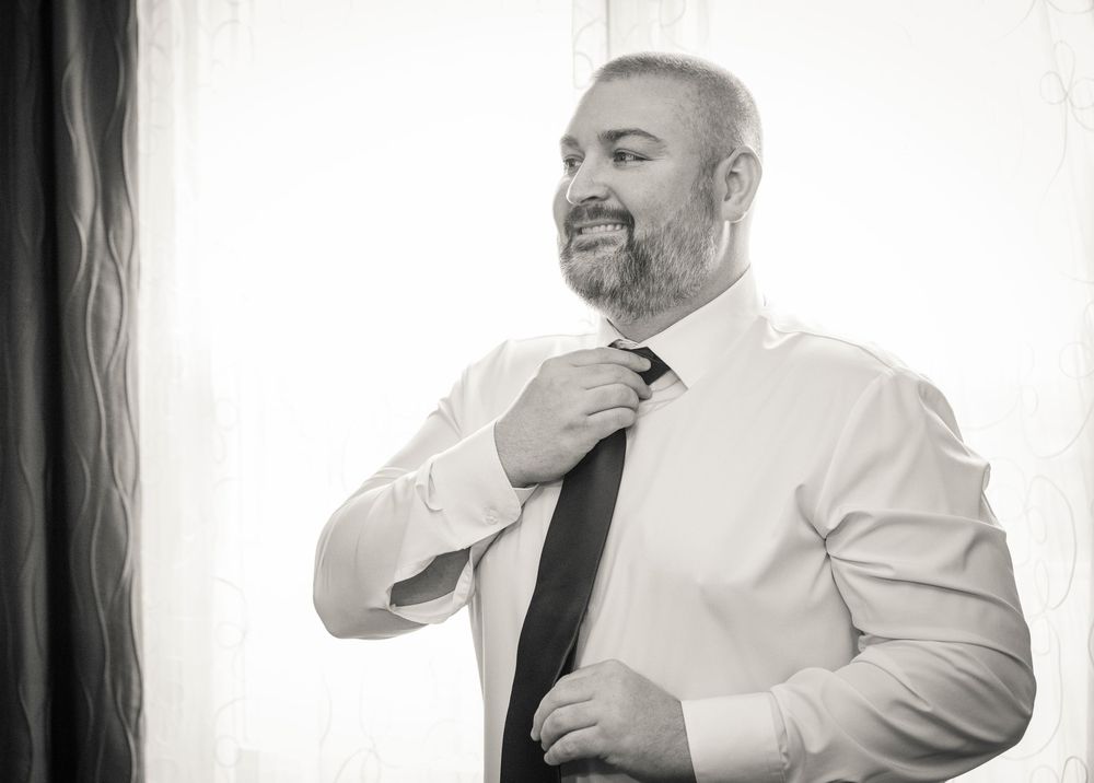 A series of candid black and white photos showing tender moments during a wedding celebration.