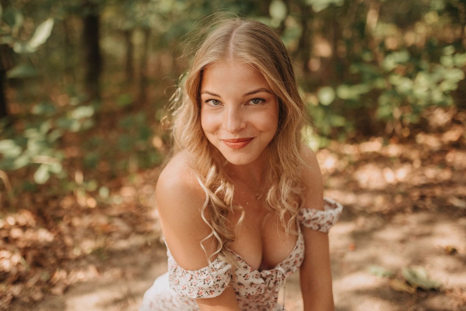 Romantic portrait captured in a wooded setting with soft natural lighting.